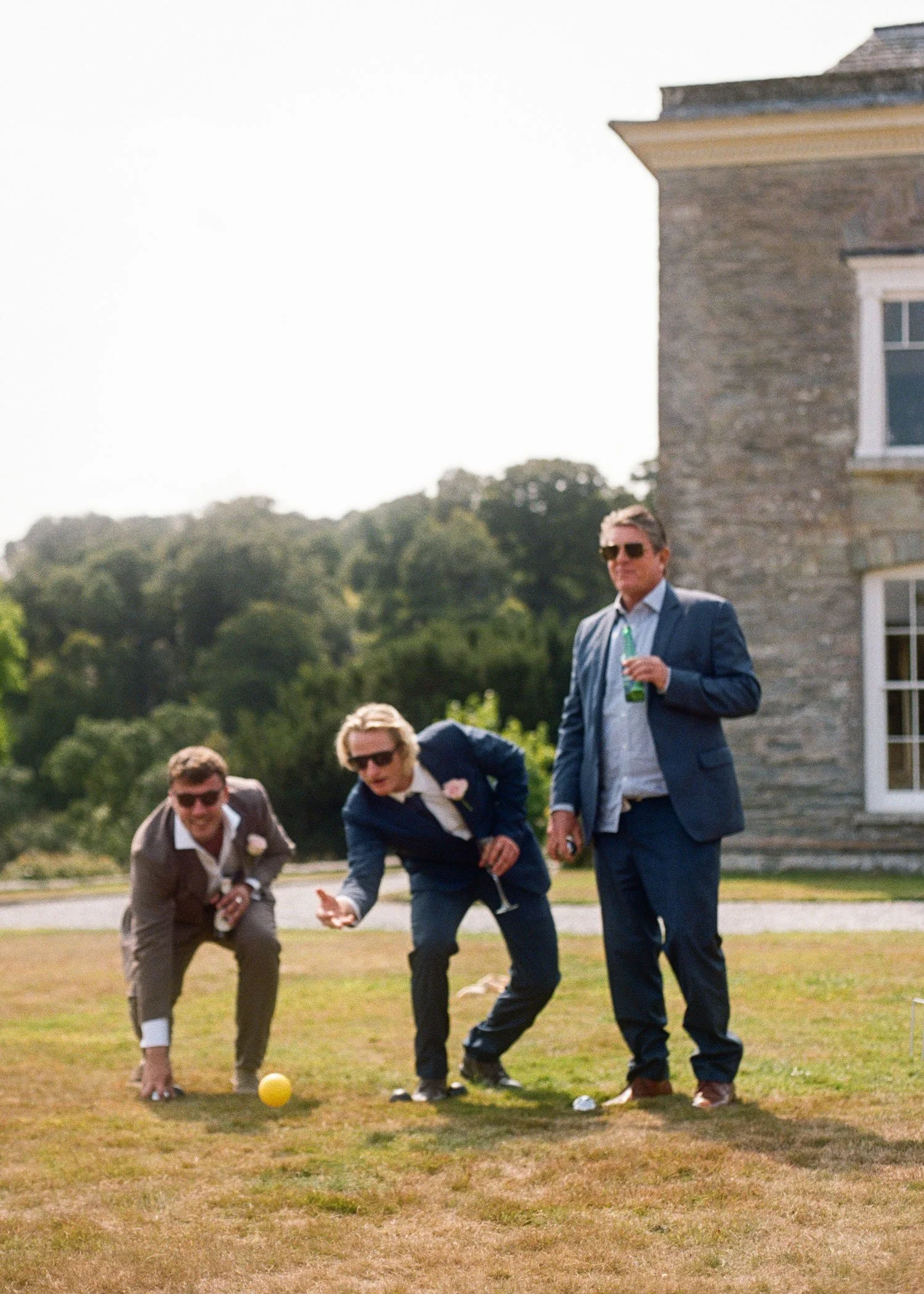 Editorial 35mm film wedding photograph of guests playing lawn games during reception