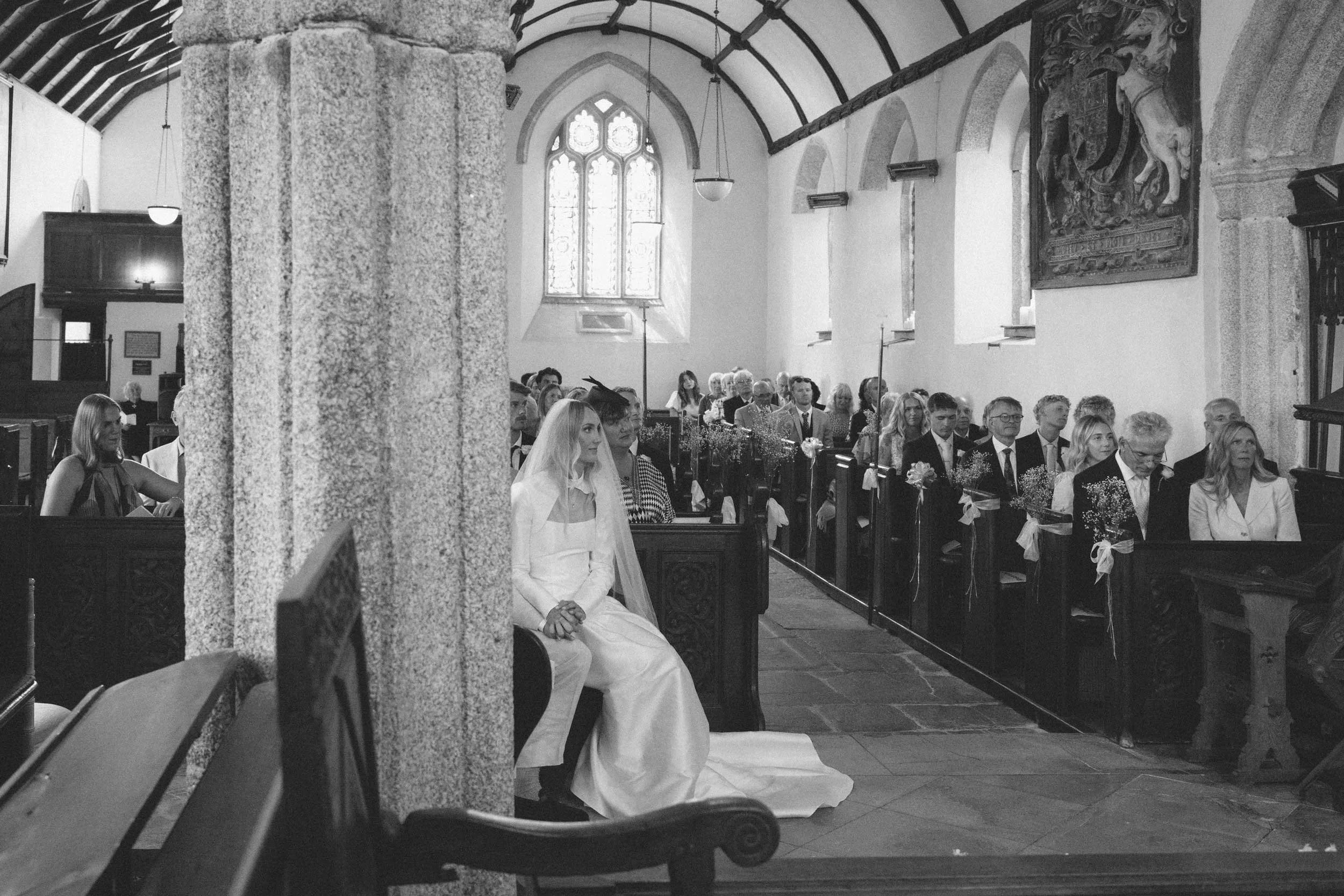 Black and white documentary wedding photography on film, bride and groom during church ceremony