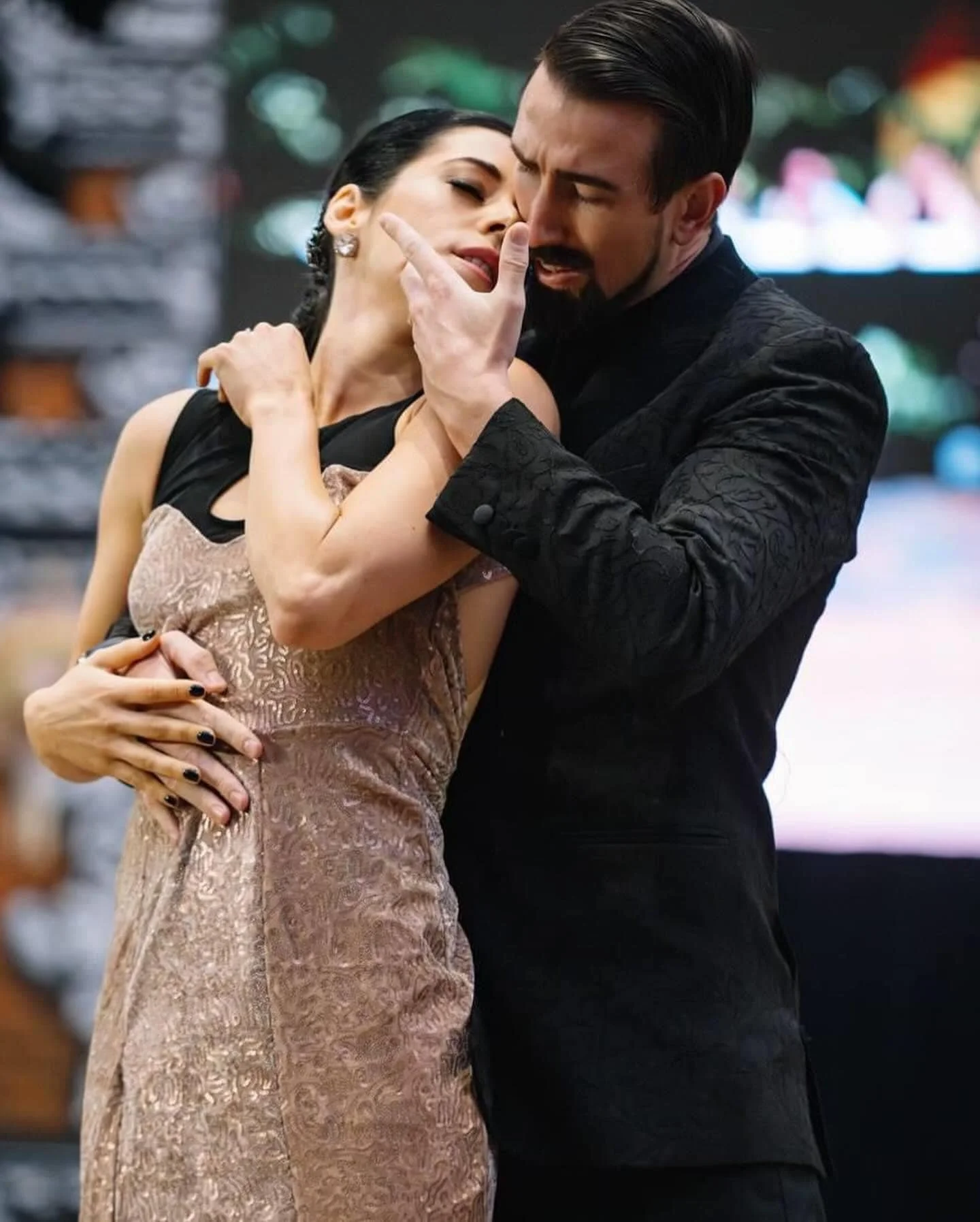 Emotional tango pose with dancers in a still, intimate embrace, capturing deep connection and raw emotion