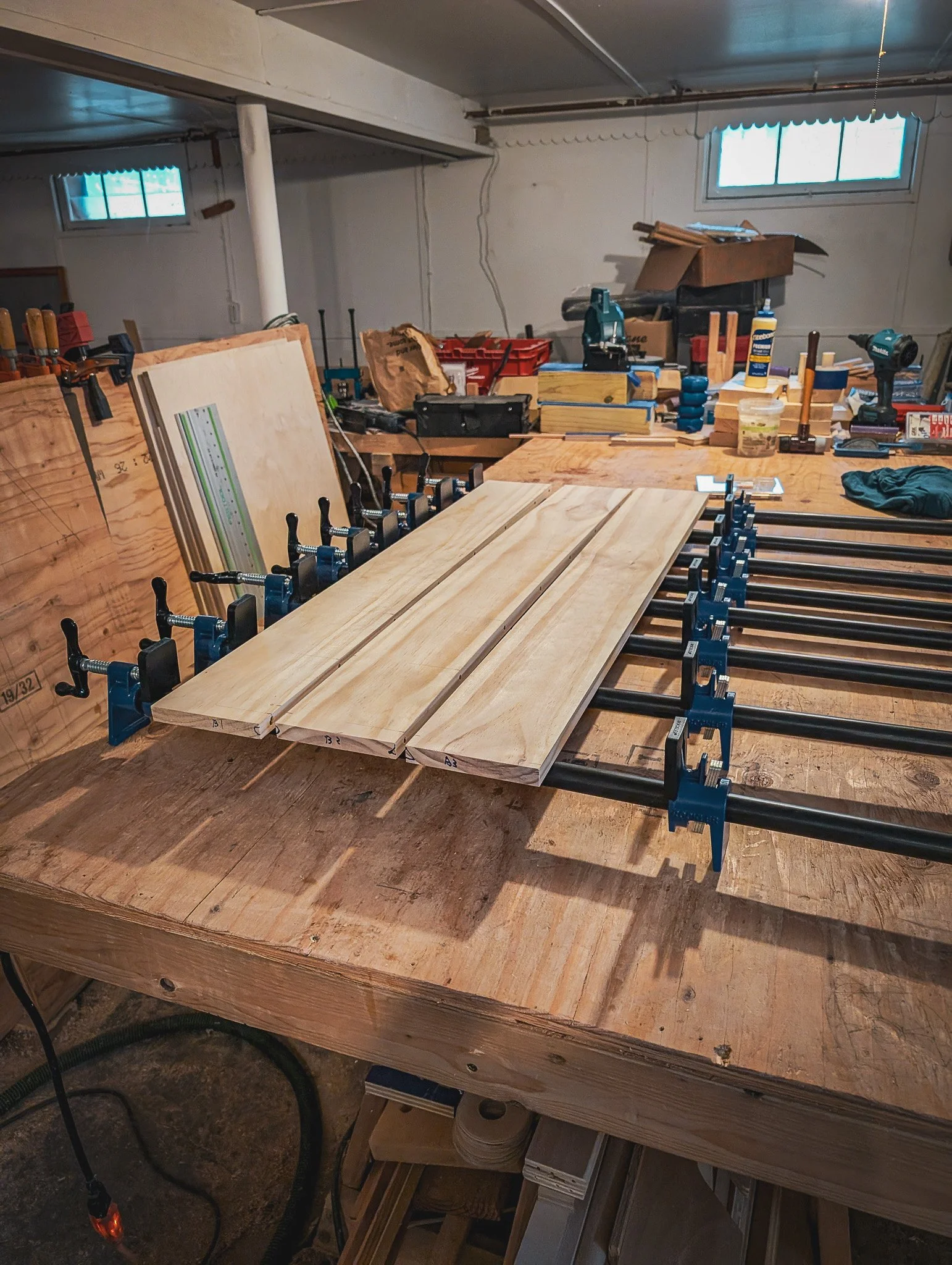 The back and front of the coffin are constructed from three planks of pine which are pegged and glued together, then sanded.
