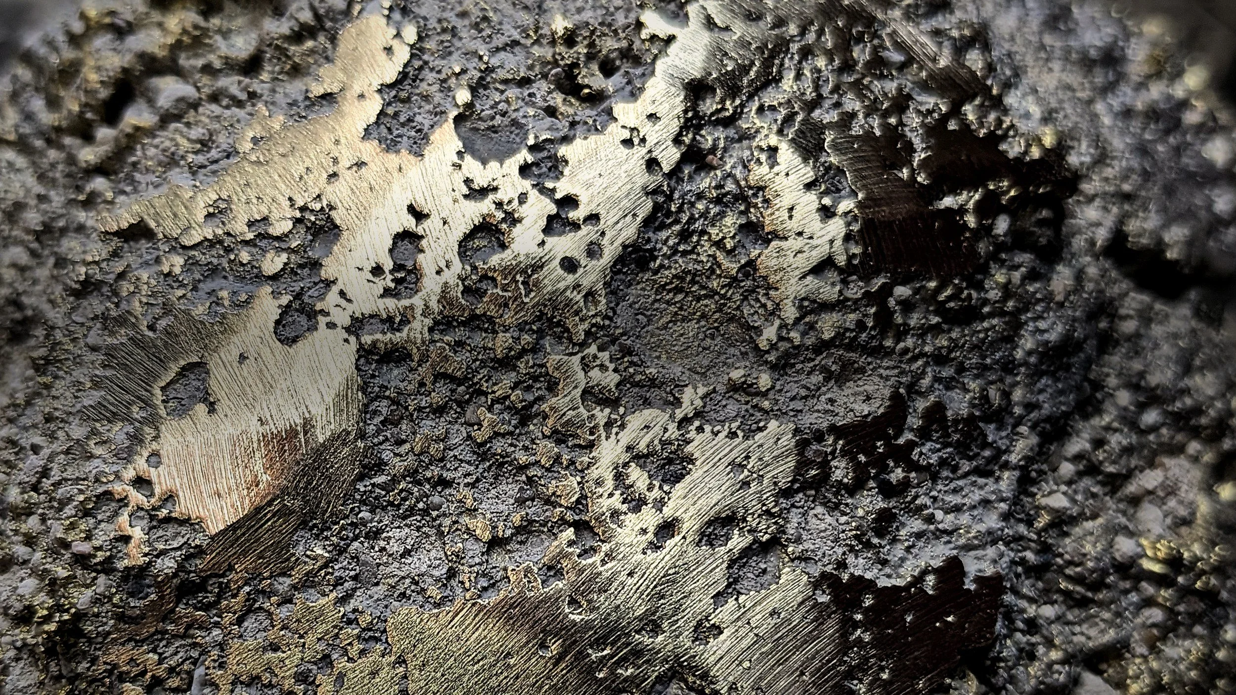 Lost-wax cast metal emerging from its ceramic shell, AmorettiLAB workshop, Mexico City