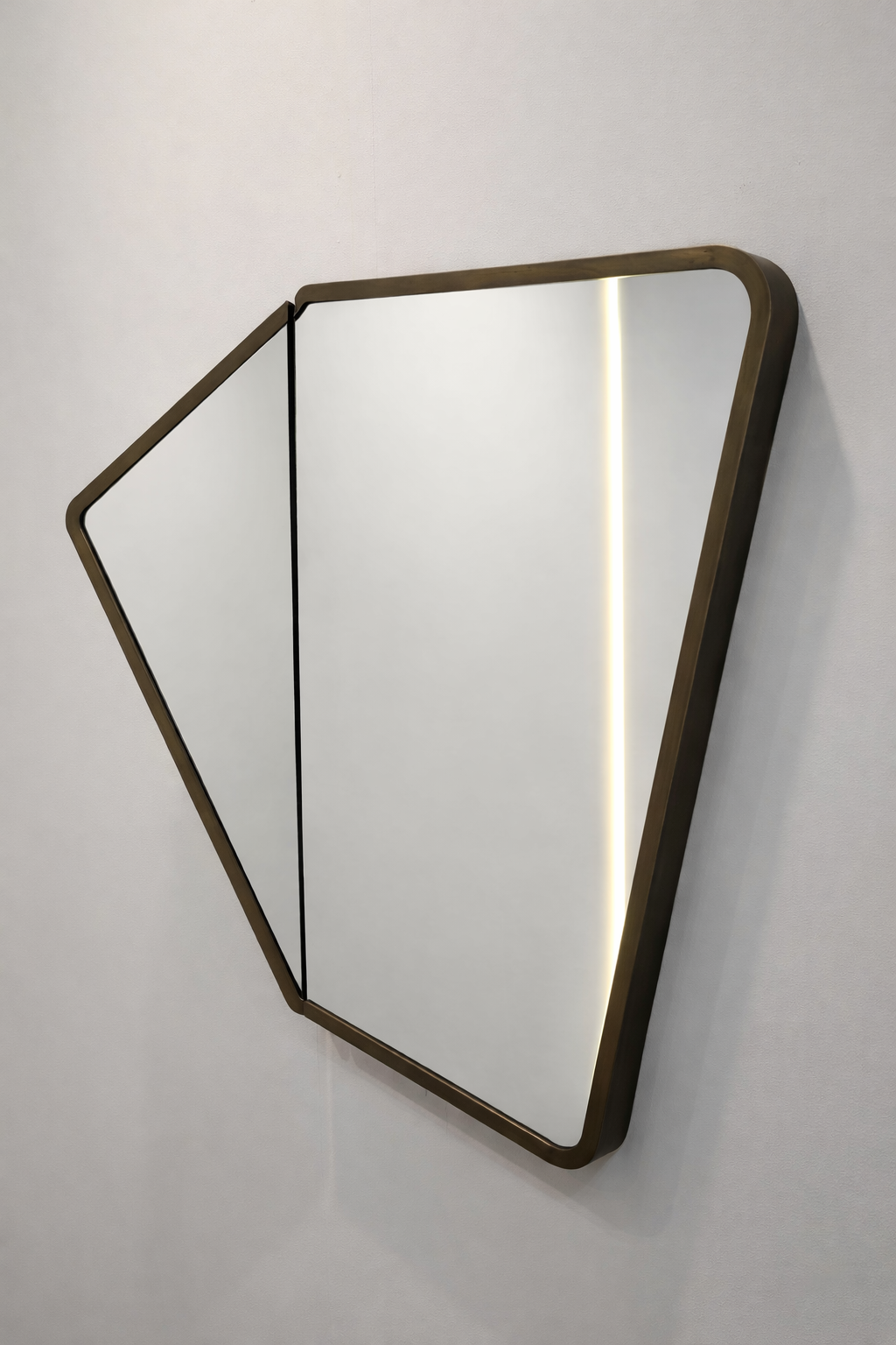 Minimalist wall mirror with a wooden frame and integrated LED lighting, mounted on a white wall.