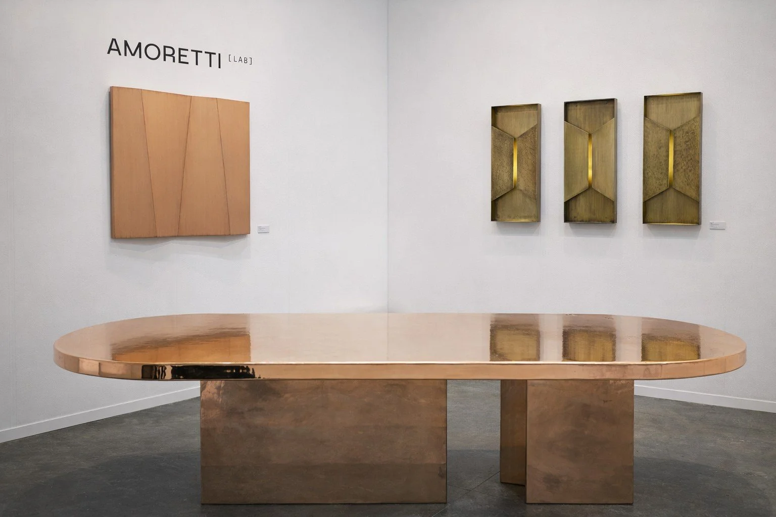 Oval copper dining table by AmorettiLAB, with copper wall art and brass sconces