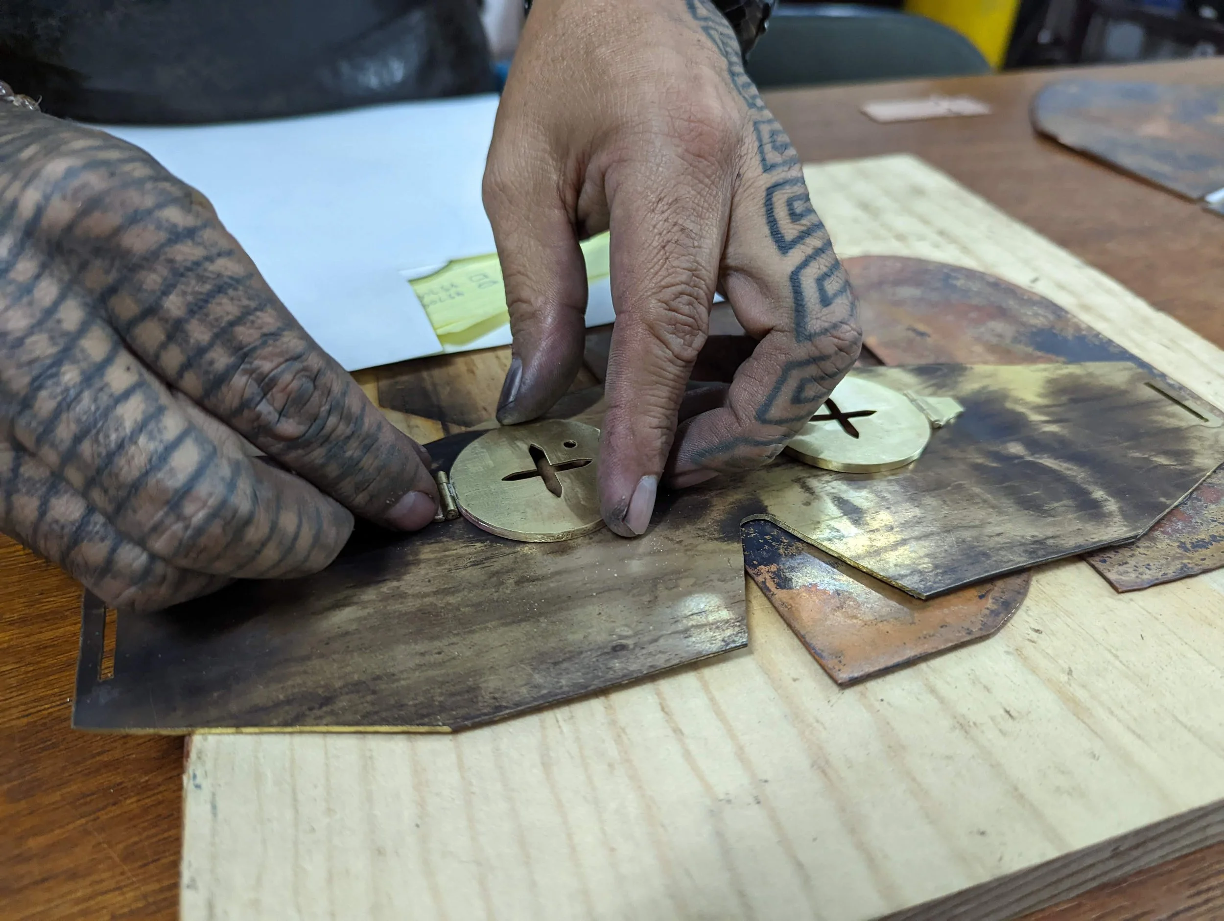 Artisan handcrafting brass for the Carla Fernández × AmorettiLAB collaboration