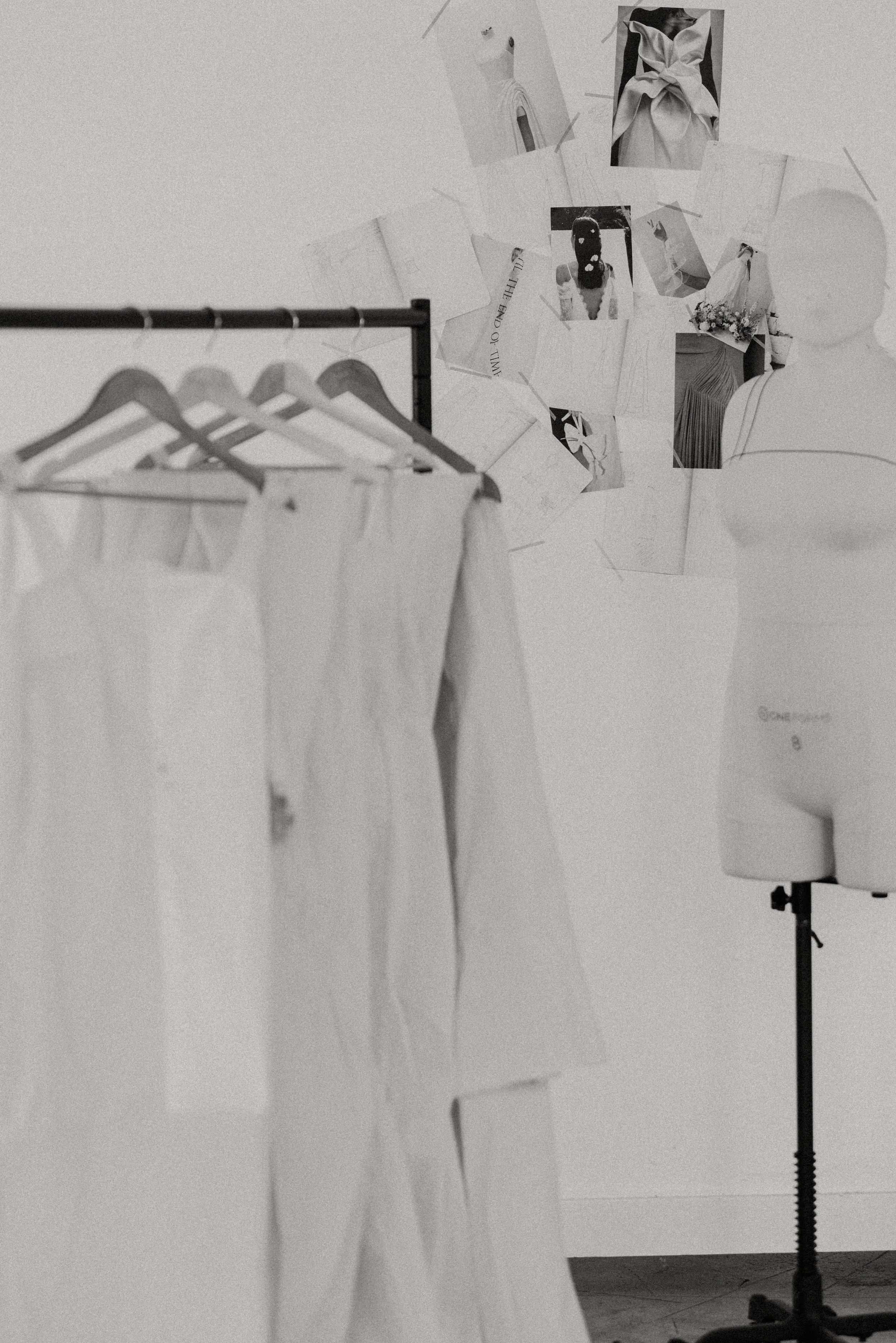 a Z-rack full of muslin mock ups of gowns and a mannequein