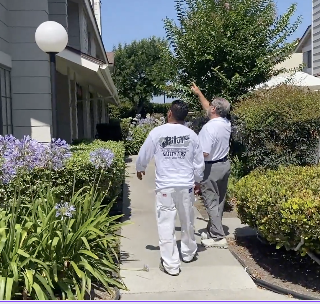 Exterior painting crew working on a large apartment complex and multi-family community repaint project.