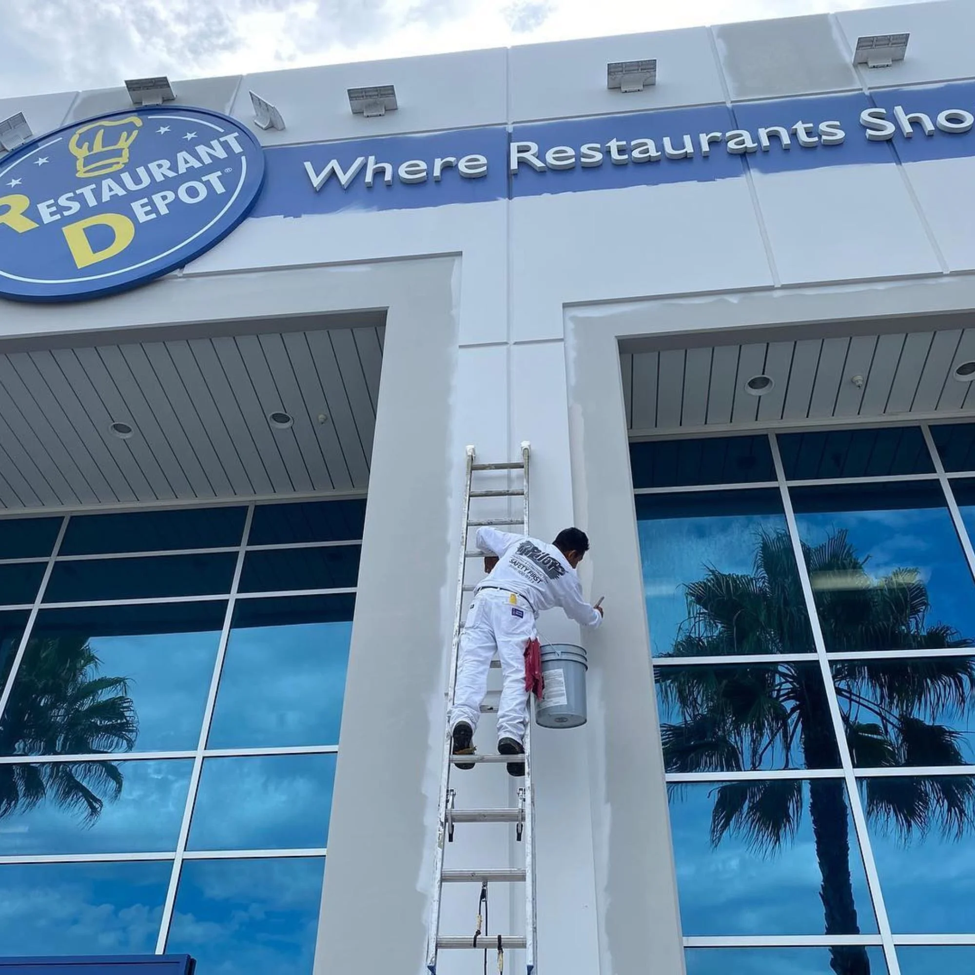 commercial exterior painting contractor working on commercial building