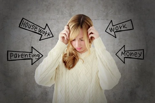 A woman with blonde hair looking stressed, with arrows pointing to her indicating she is overwhelmed by house work, work, parenting, and money.