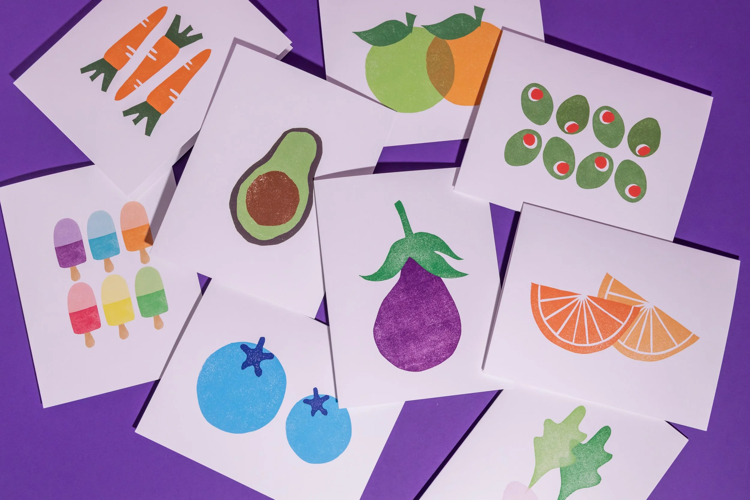 An array of hand-stamped linocut cards featuring produce. Designed by Andrea Morris Studio.