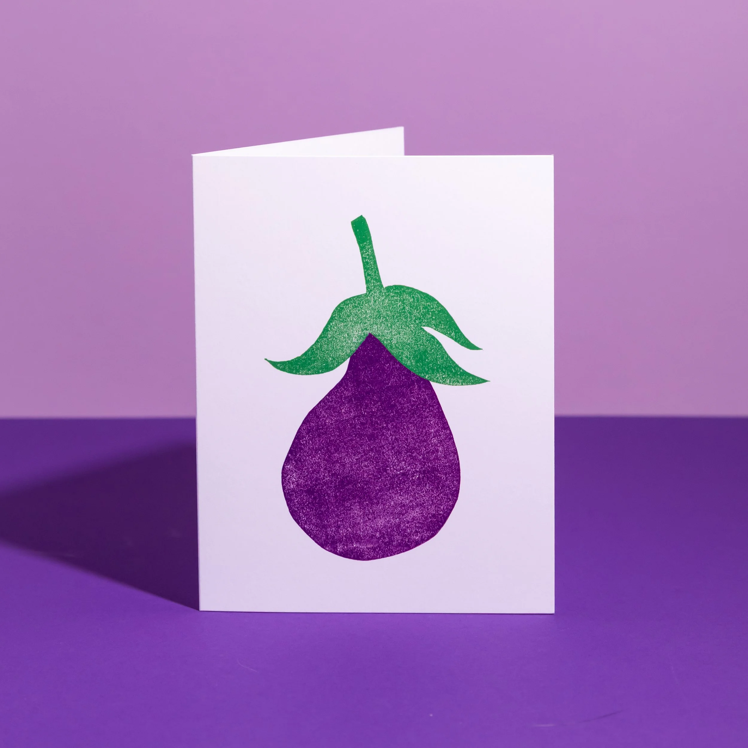 A hand-stamped linocut card featuring an eggplant. Designed by Andrea Morris Studio.