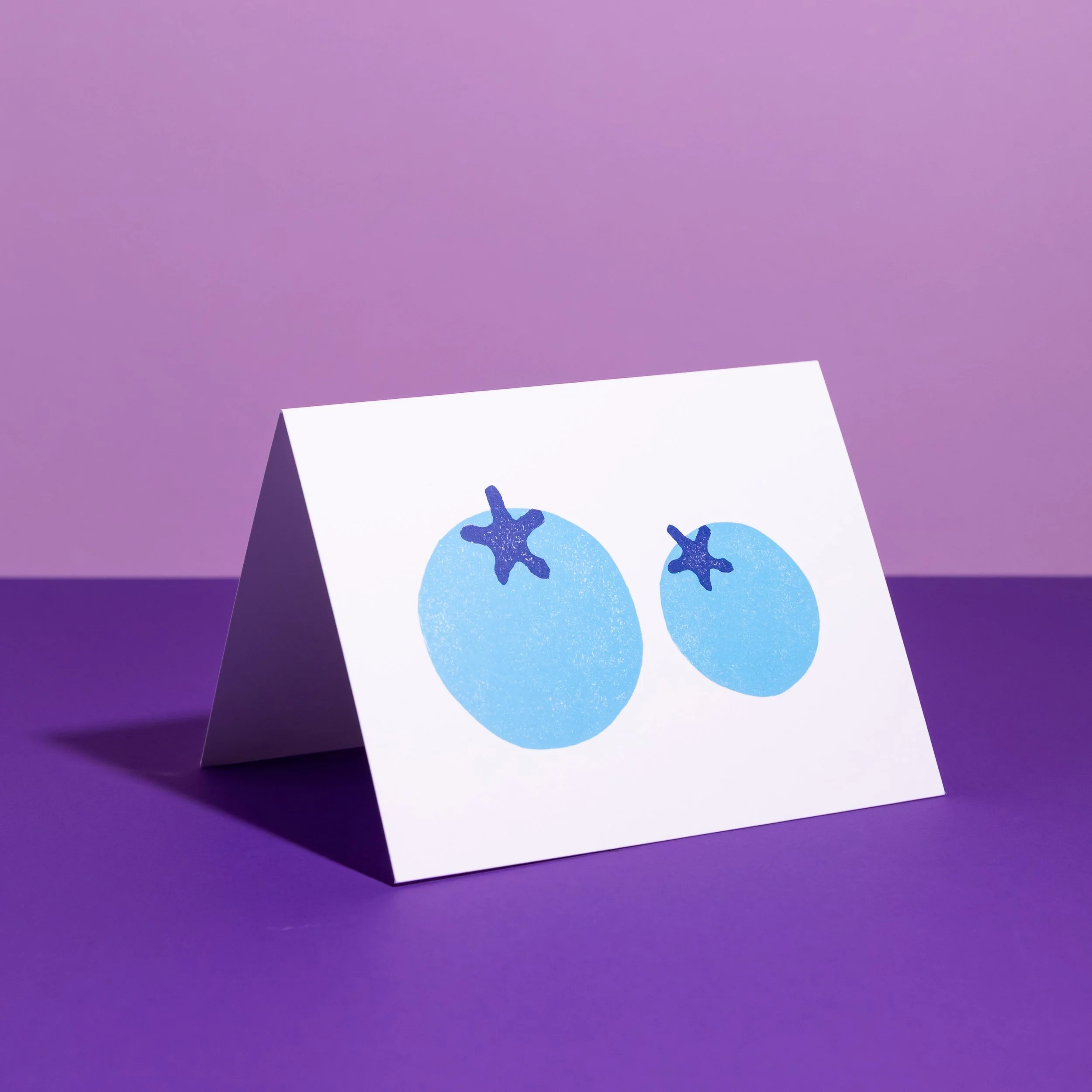A hand-stamped linocut card featuring blueberries. Designed by Andrea Morris Studio.