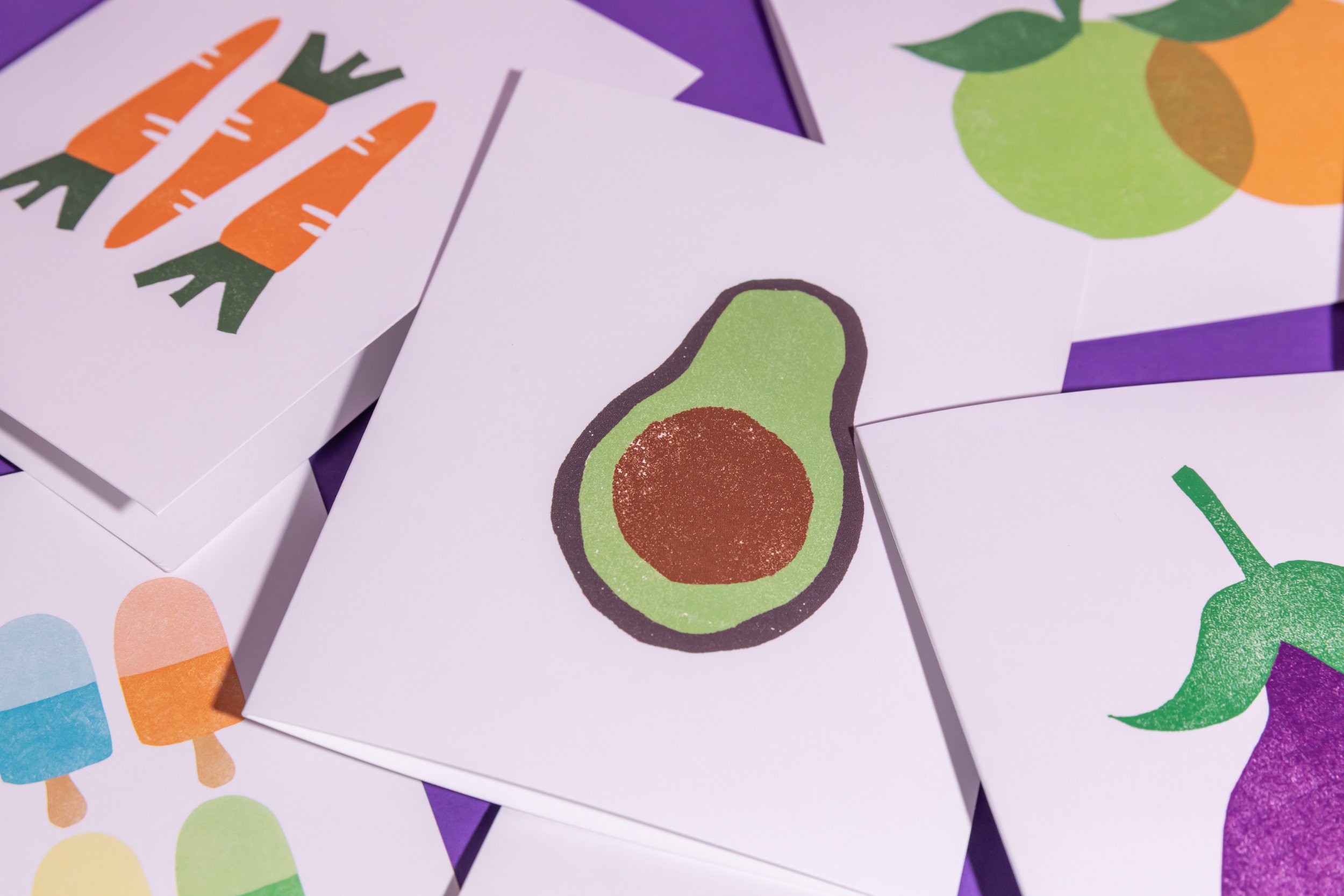 An array of hand-stamped linocut cards featuring produce. Designed by Andrea Morris Studio.