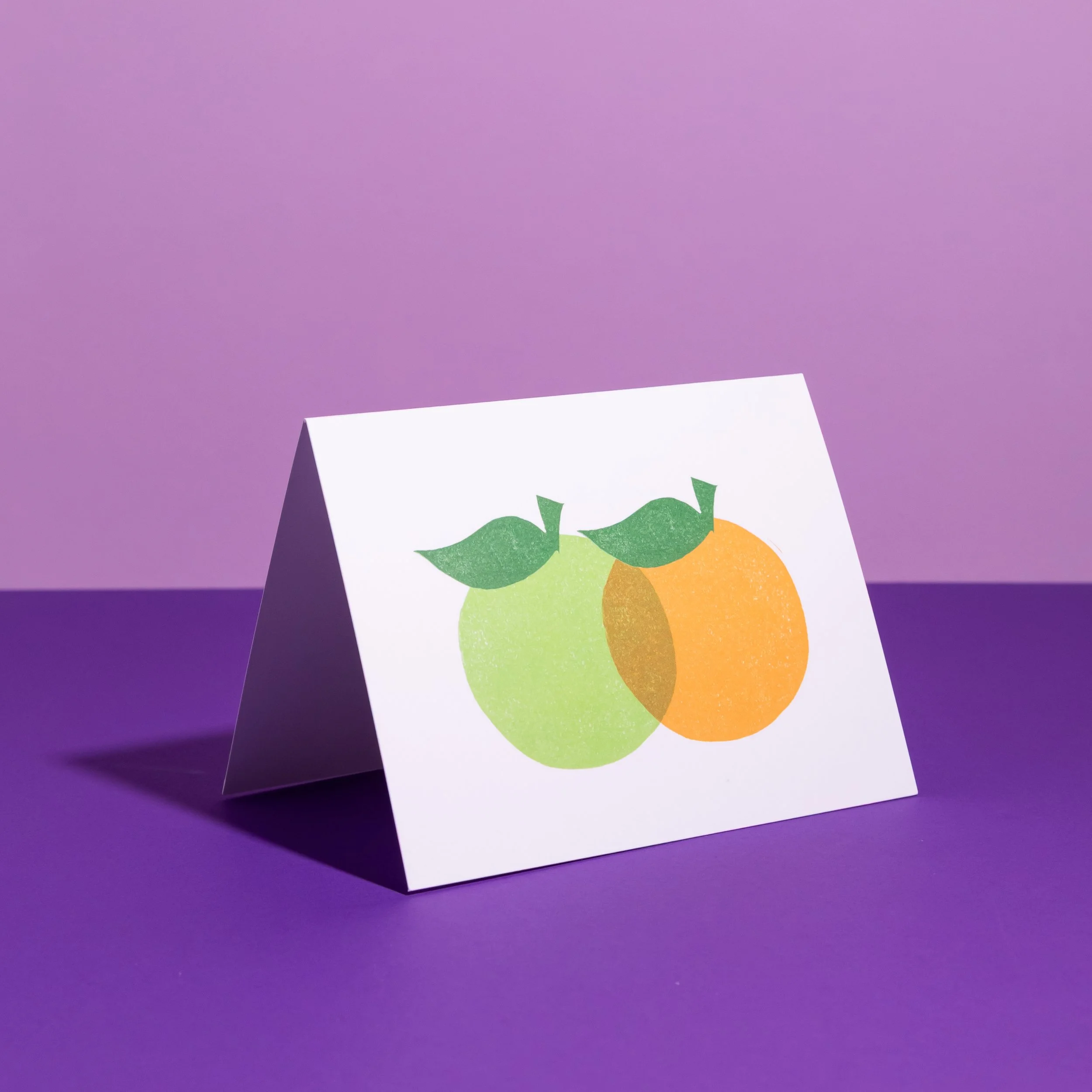 A hand-stamped linocut card featuring oranges. Designed by Andrea Morris Studio.