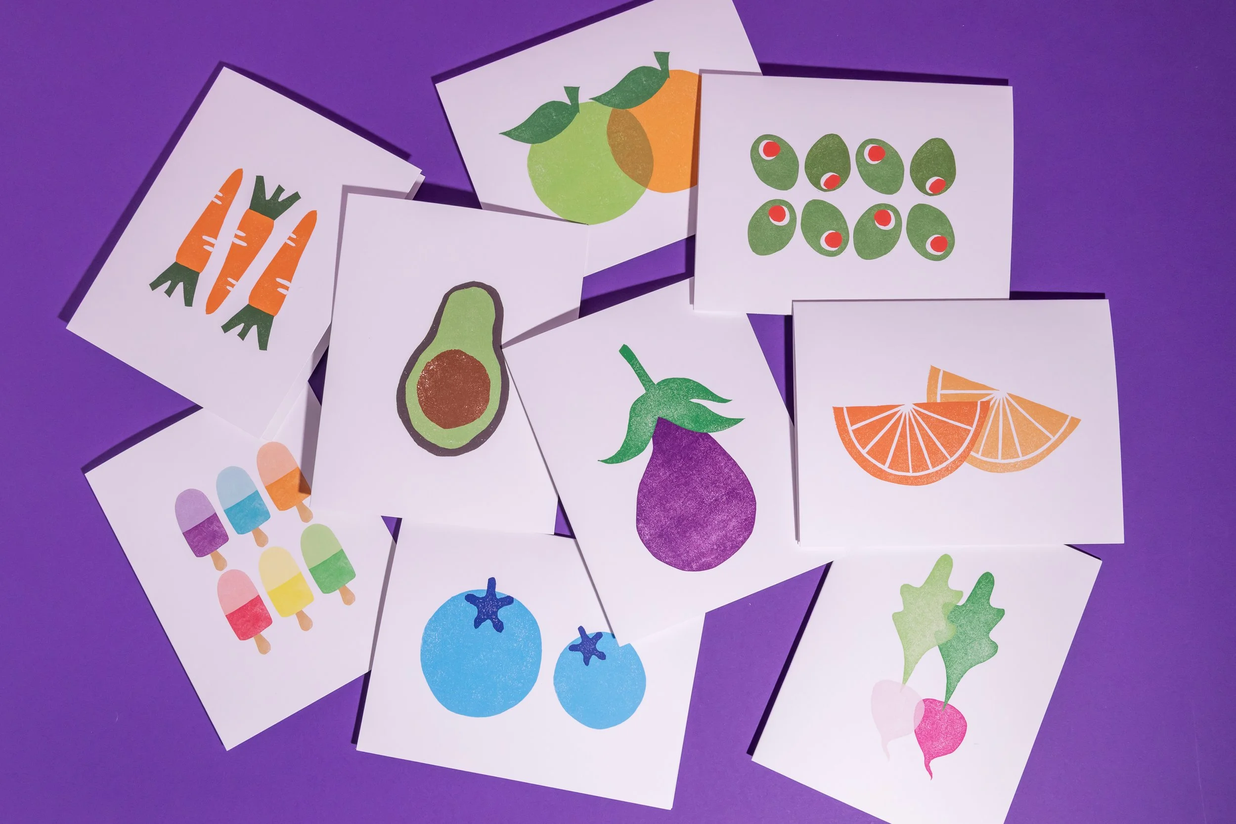 An array of hand-stamped linocut cards featuring produce. Designed by Andrea Morris Studio.