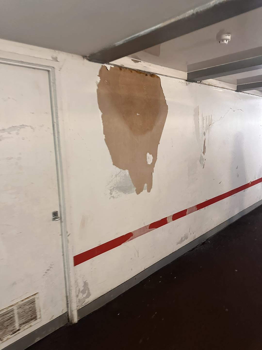    Damaged, peeling walls at Stockport station.   