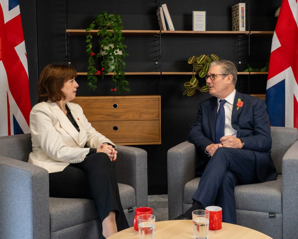 Photo of Angela Rayner and Keir Starmer smiling and chatting on a street.