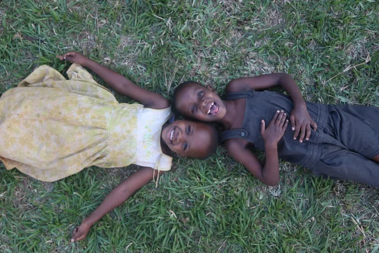 Children Smiling in the Grass