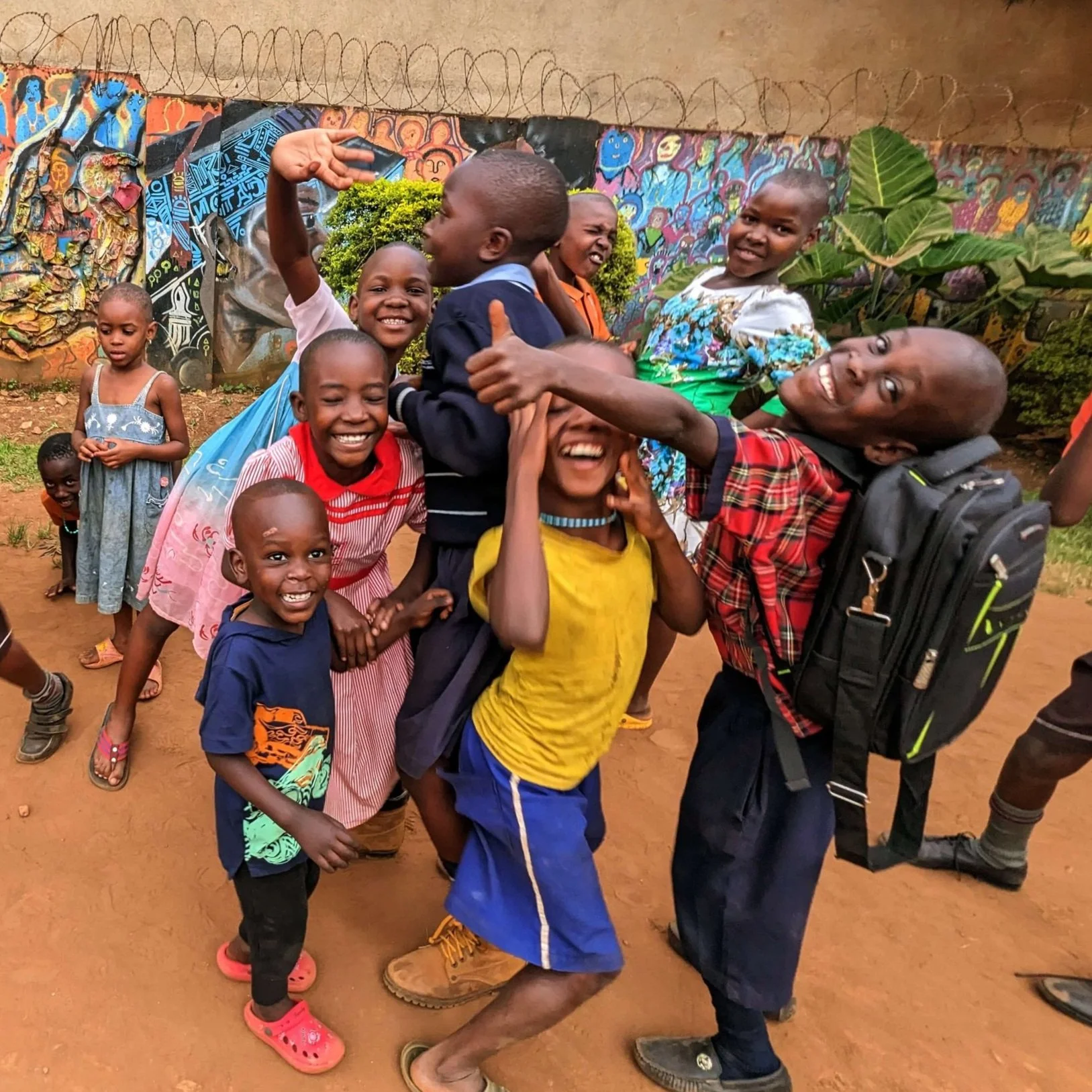 Group of children smiling at the Uganda Center.