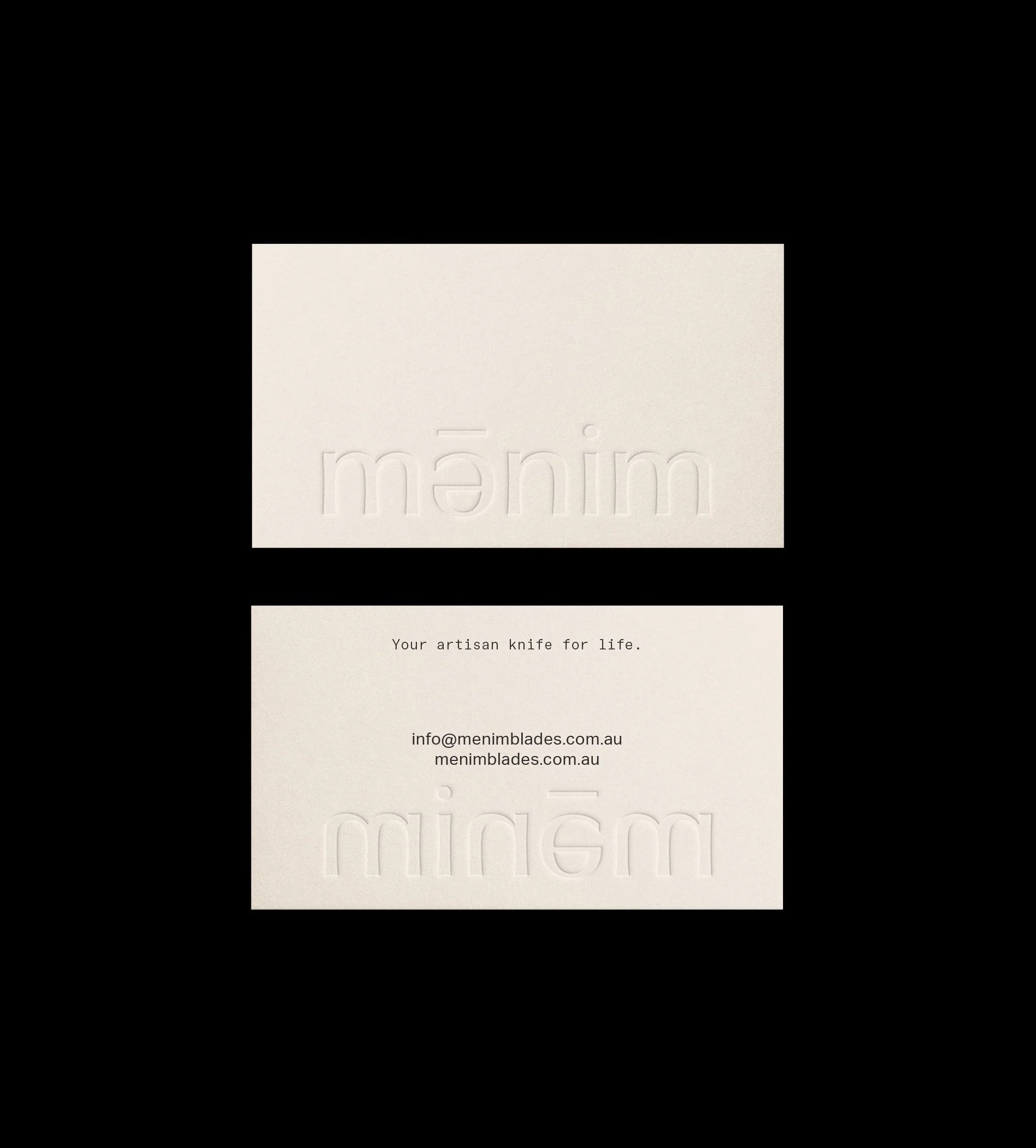 Business cards for Menim Blades with embossed logo on one side and contact information including email and website on the other, placed against a black background.