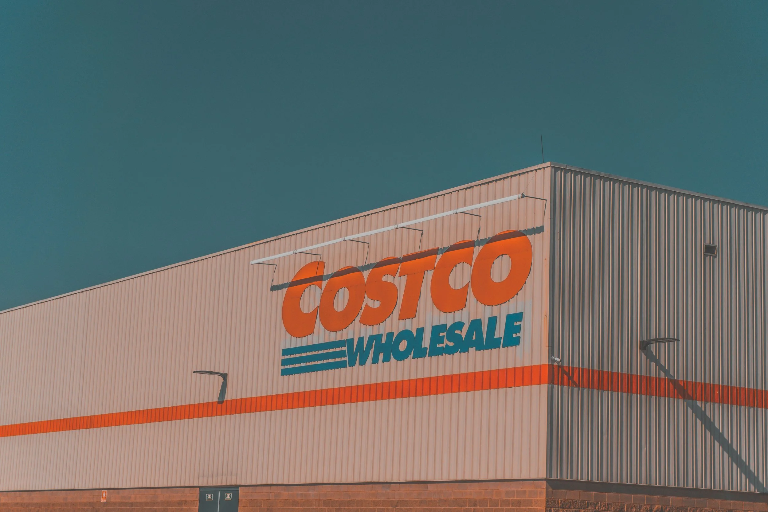Photo of a Costco Wholesale sign on one of their warehouse buildings.