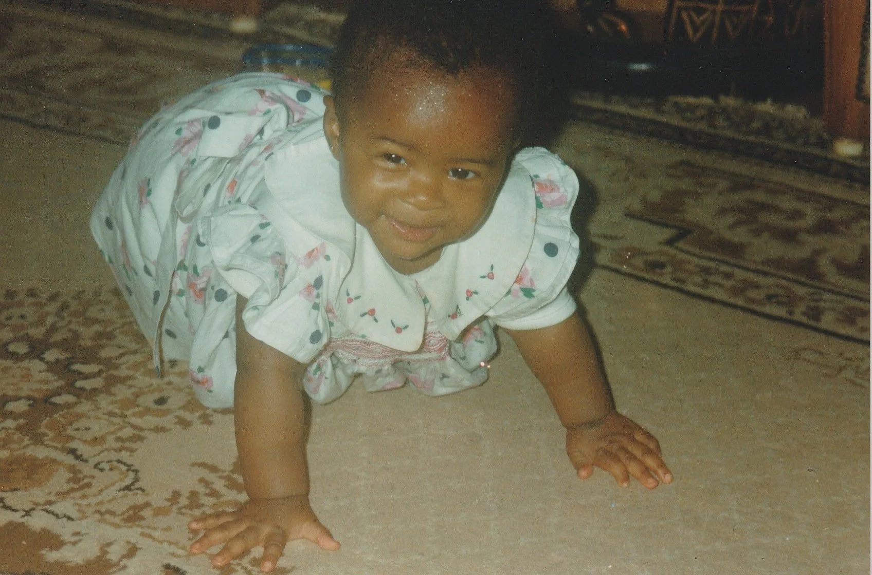 Daisy as a baby first learning to crawl (Cameroon, 1990s)