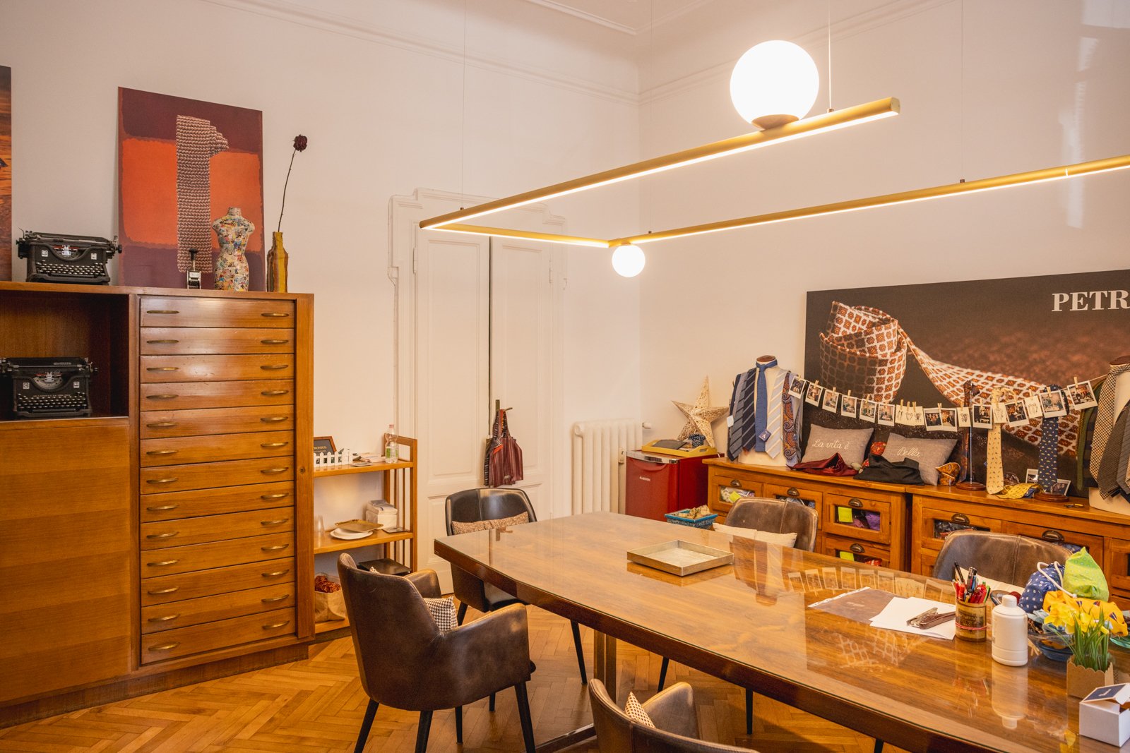 Modern showroom or office space within Petronius 1926, elegantly lit and displaying accessories.