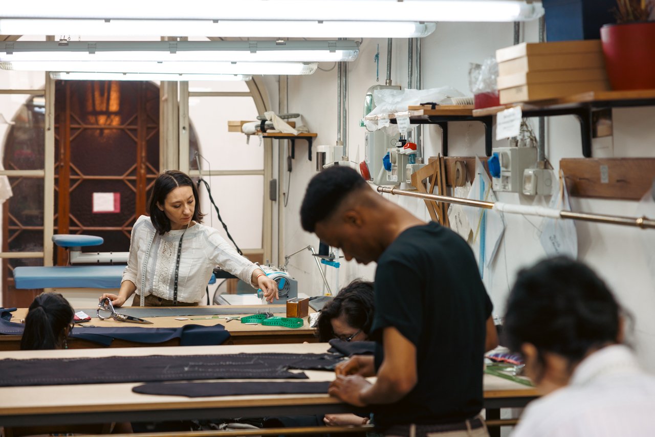 Overview of the busy Liverano workshop with several tailors at work.