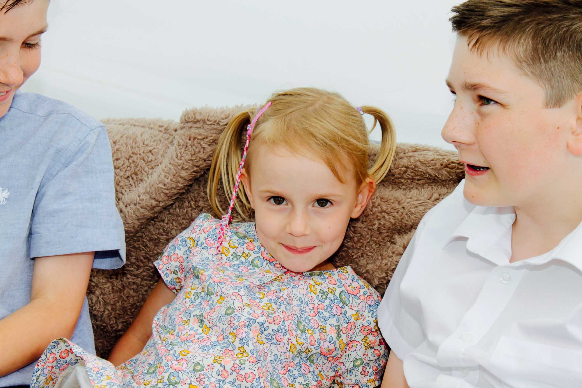 girl-smiling-at-camera-family-photographer.jpg