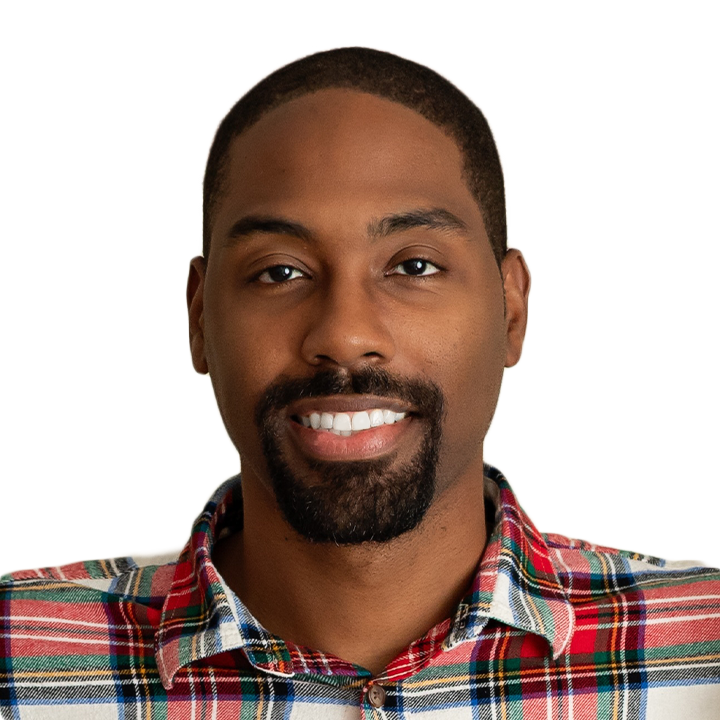 Professional headshot of Josh Davis, Enrolled Agent, smiling at camera wearing a red plaid shirt against a white background