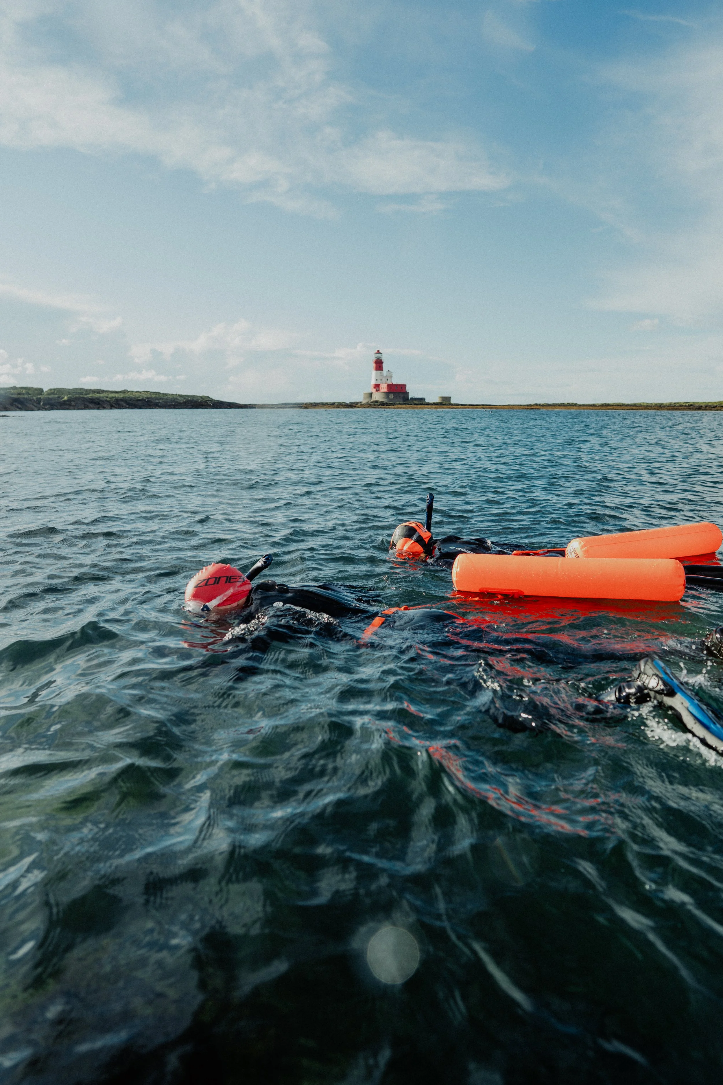 Swimmers at Longstone island, the furthest island from shore. With tow floats to keep them safe.