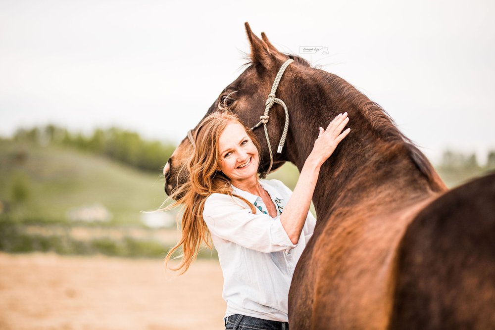 Woman and Bay Horse hugging