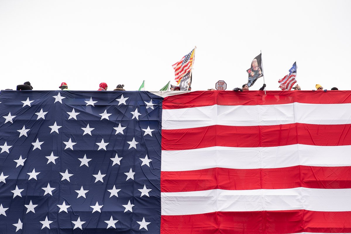 United by Stars and Stripes, a crowd holding flags and signs attempts to make their voices heard on Capitol Hill. January 6, 2021. Washington D.C.