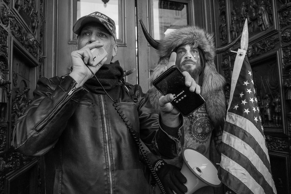 Jacob Chandler, a.k.a. the ‘QAnon Shaman,’ and another fellow protester urge demonstrators to disperse at the west entrance of the Capitol in an effort to de-escalate the situation amid a charged atmosphere. January 6, 2021, Washington, D.C.