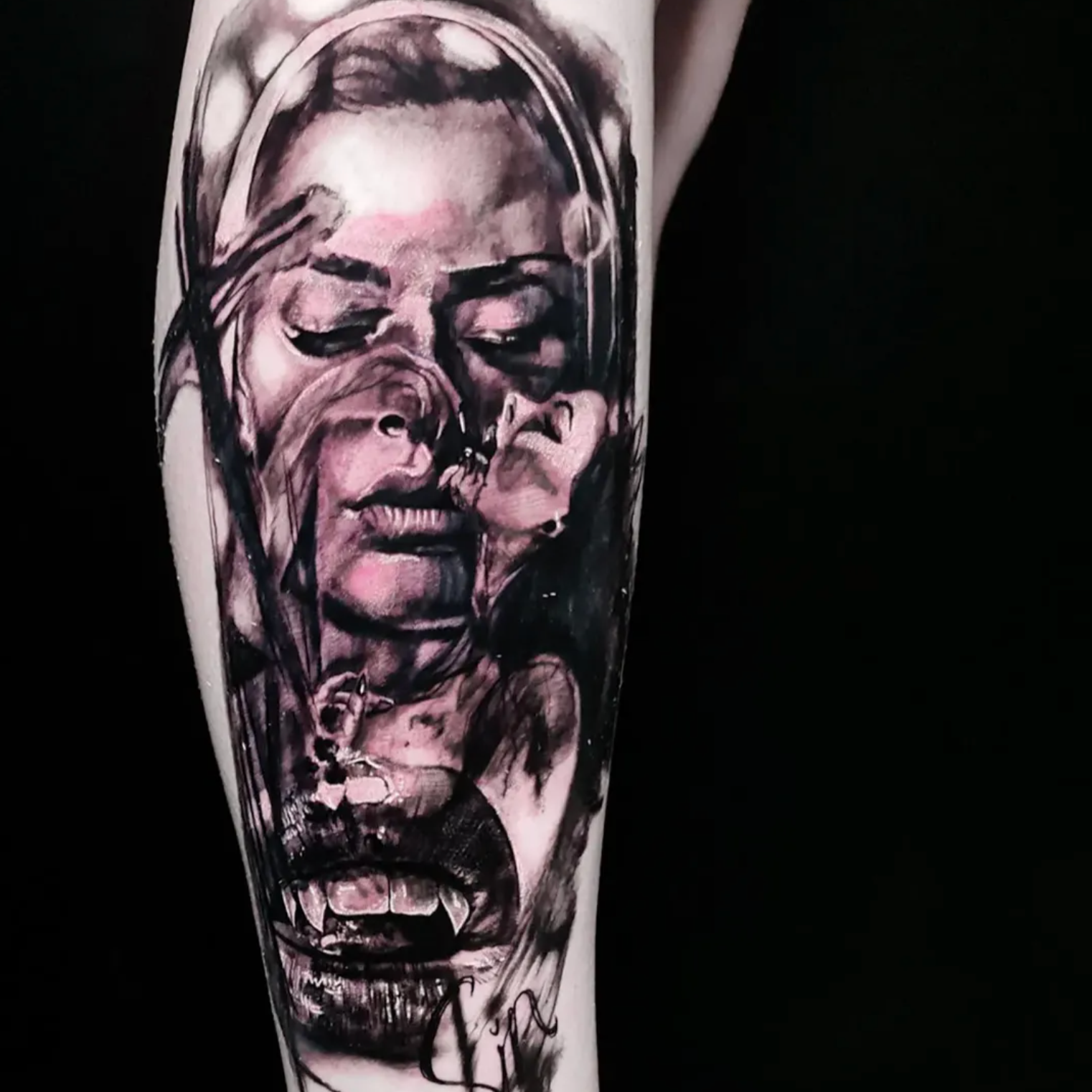 Tattoo of a human skull with a portrait of a woman inside the skull, depicted in black and pink ink on a person's arm.