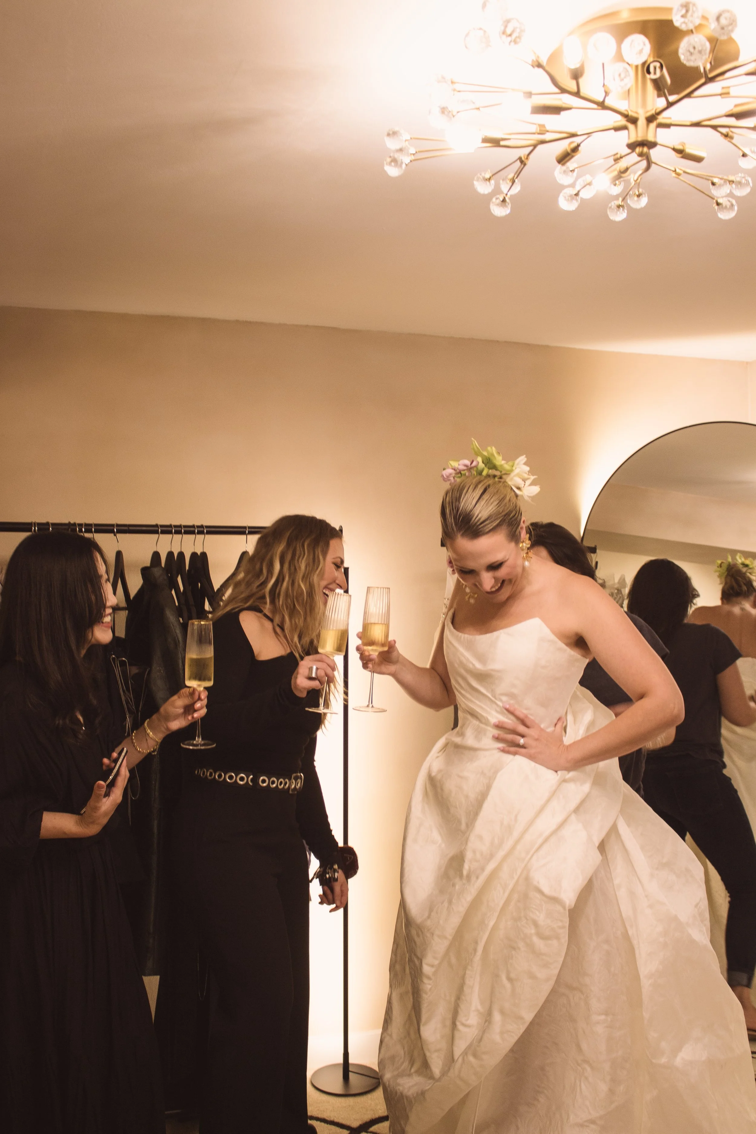 Angeline Brunk with Happy Bride Couture Muse client during final fitting toasting with champagne in her private design studio in Queen Anne for weddings and special occasion dresses and suits