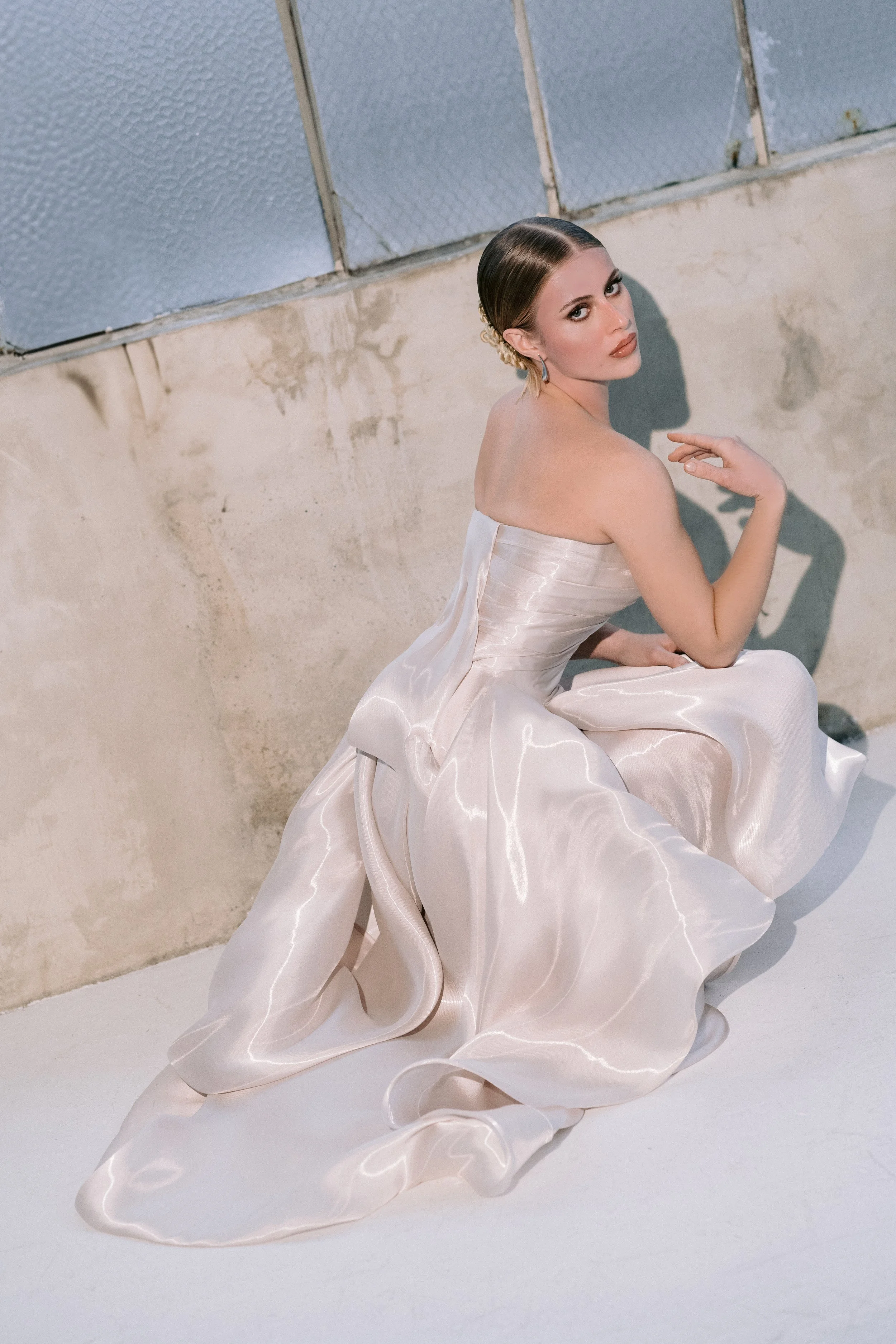 Beautiful editorial of a silvery pink liquid mikado fabric from Italy realized in a modern haute couture bridal gown by Seattle designer Angeline Brunk from her King County studio in an editorial shot by Logan Westom.