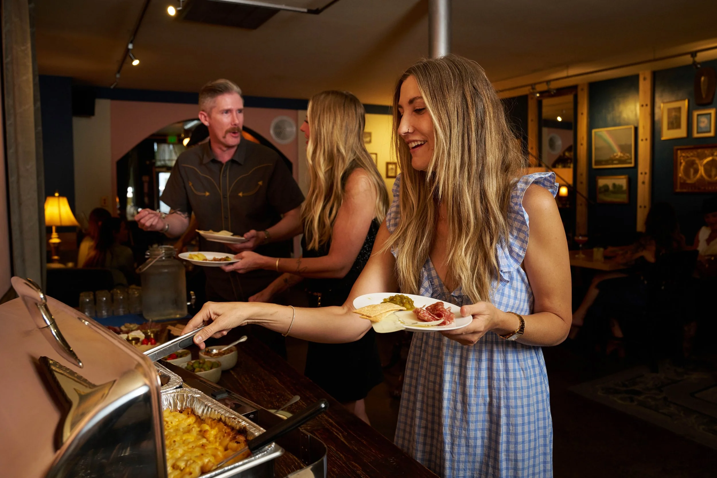 Guests enjoying a catered buffet together inside Broderick.