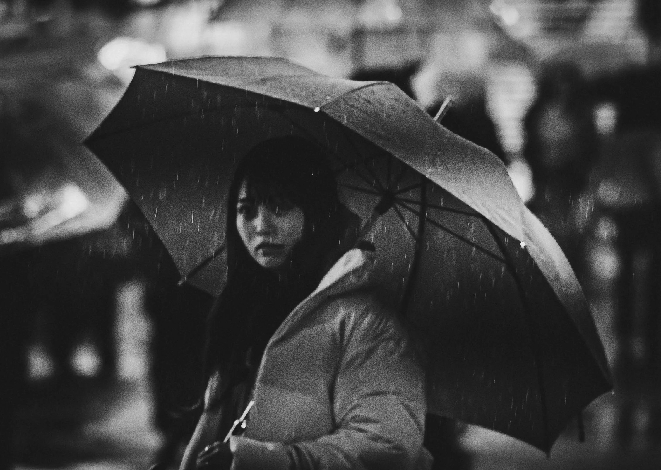 Lady standing in the rain with umbrella.jpg