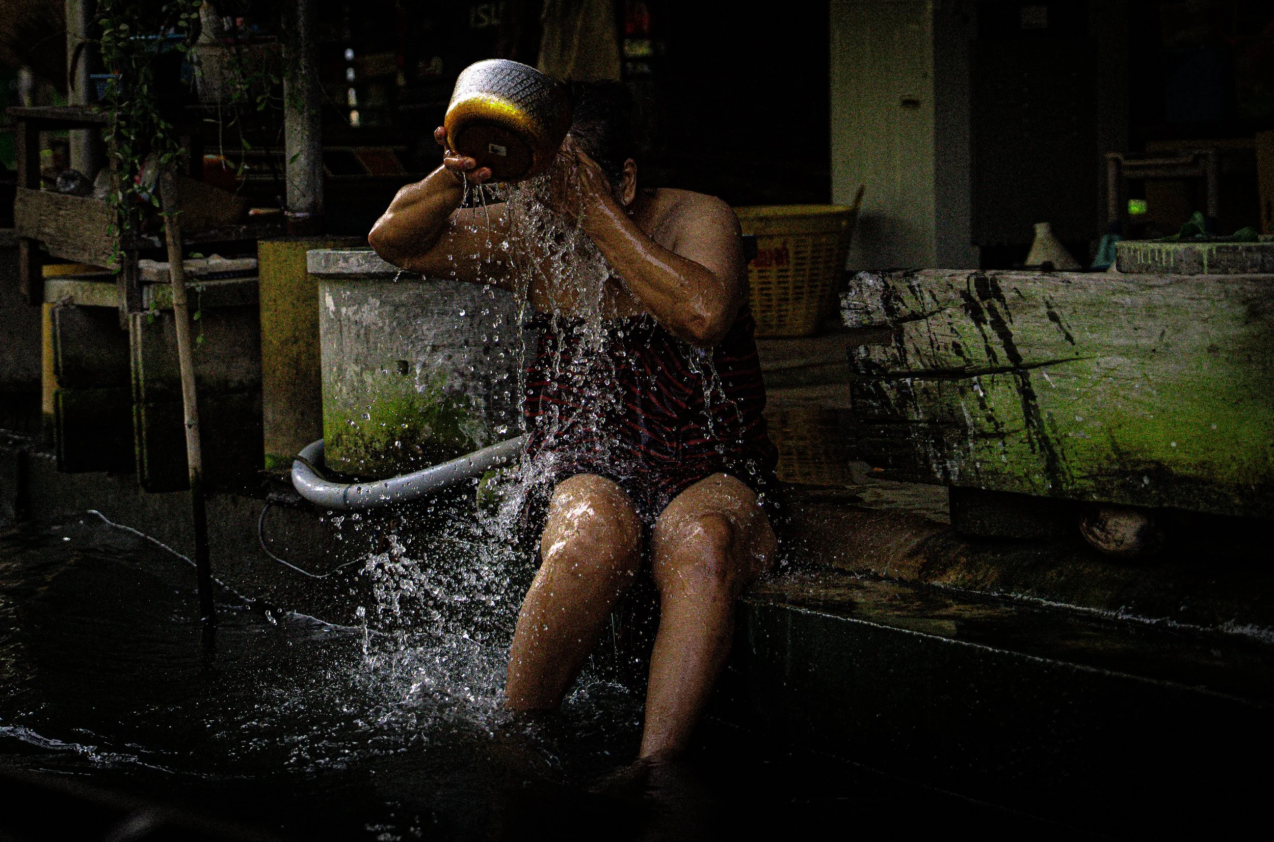 Lady washing face at floating market.jpg