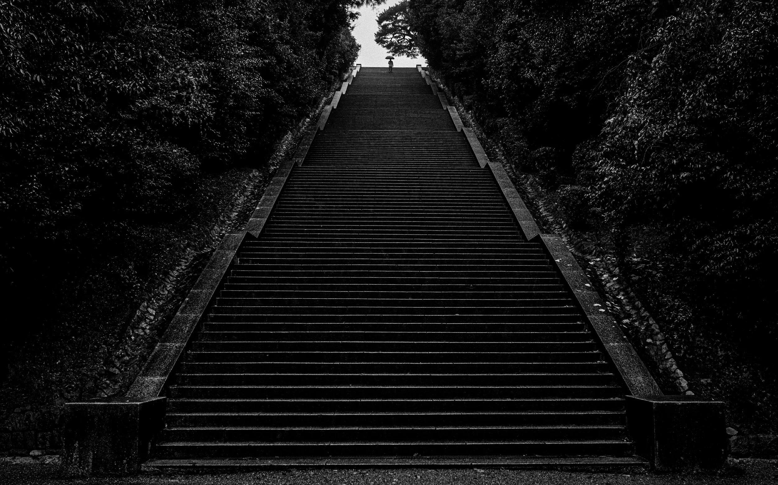 Emperor Meiji Tomb - man standing on top of stairs.jpg