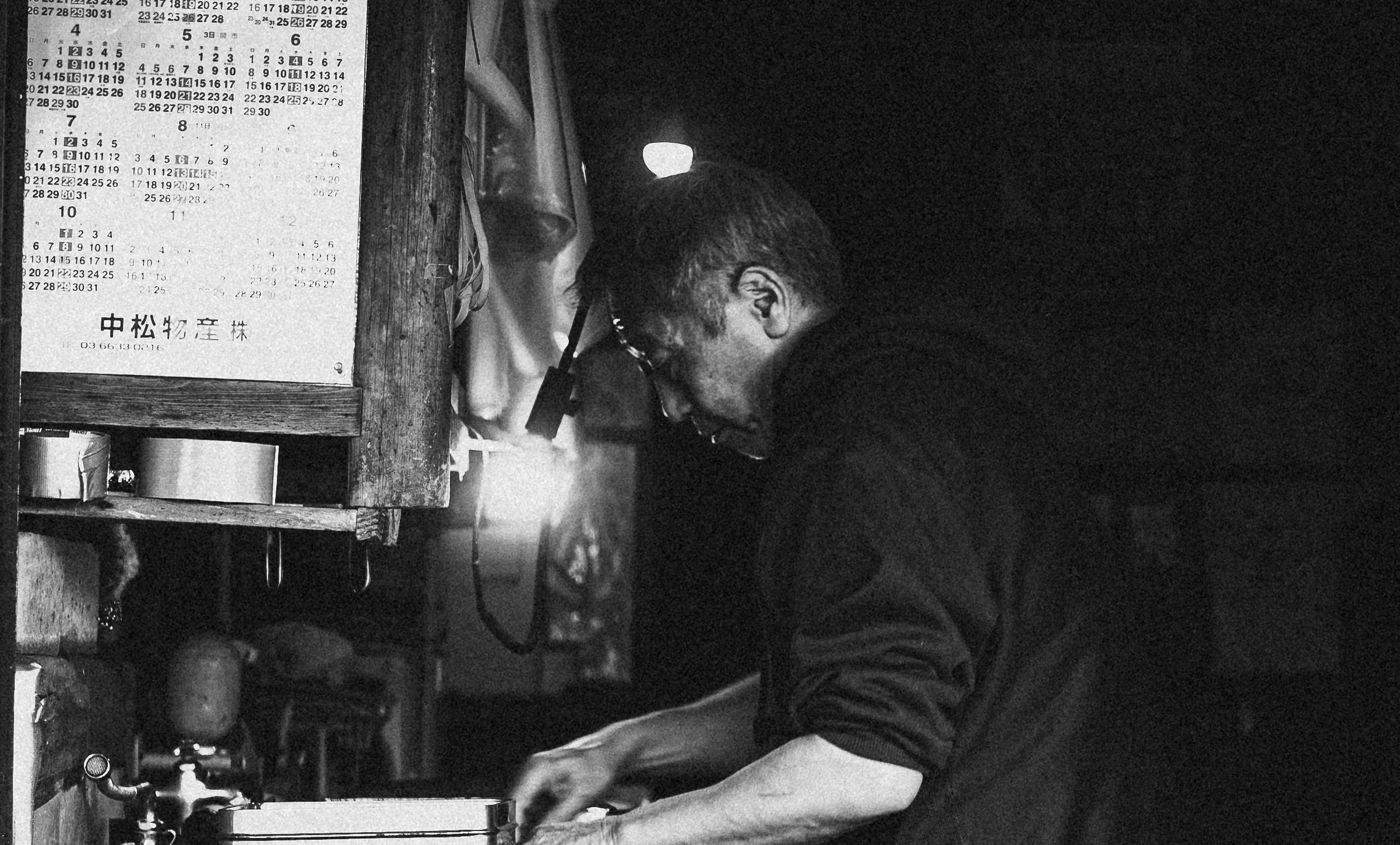 Man working at the fish market - black and white.jpg