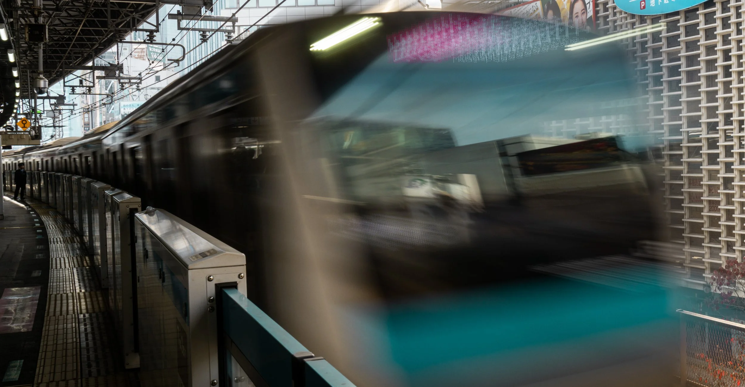 Train passing by on platform.jpg