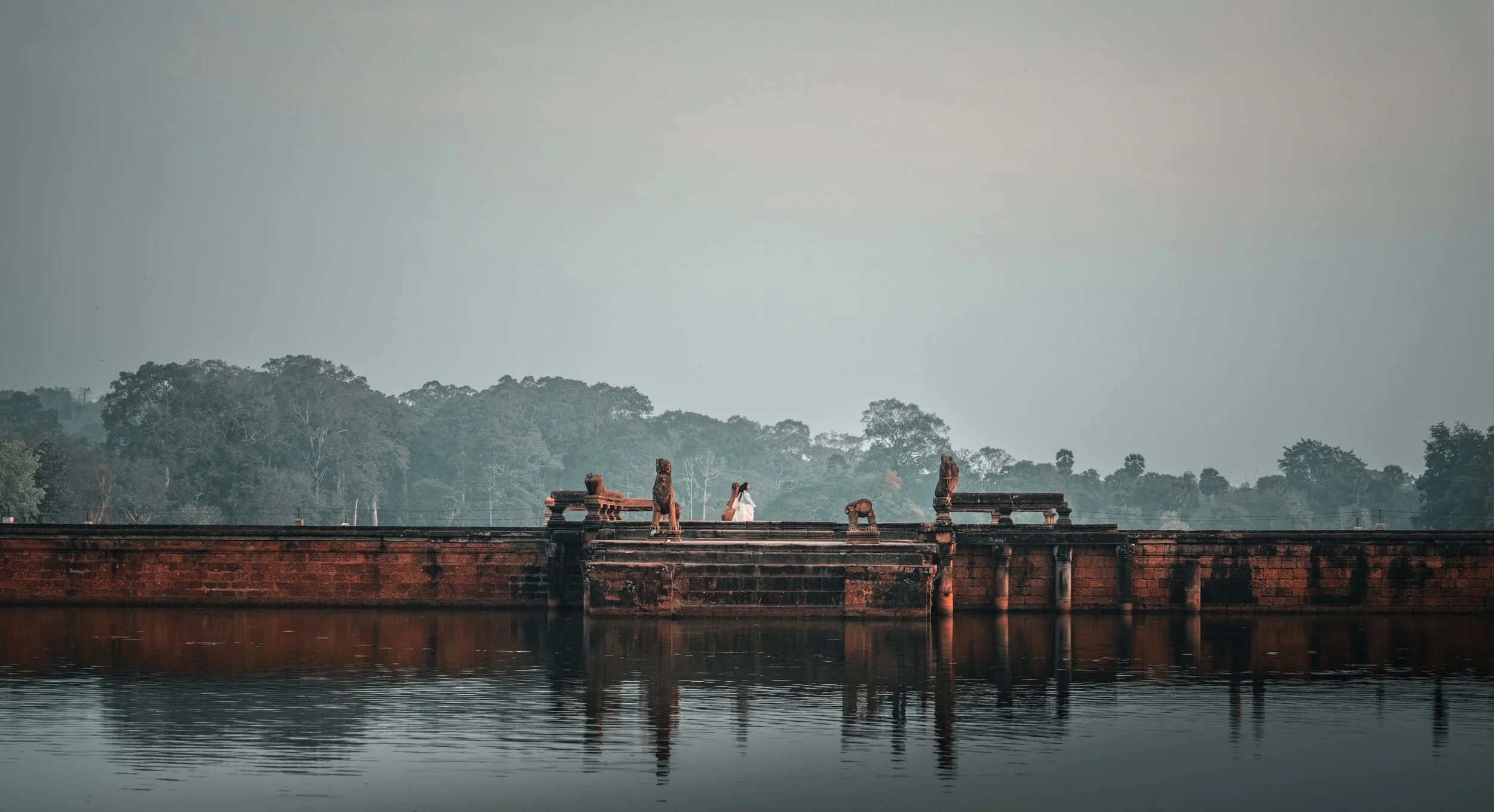 Angkor Wat - women crossing the causeway.jpg