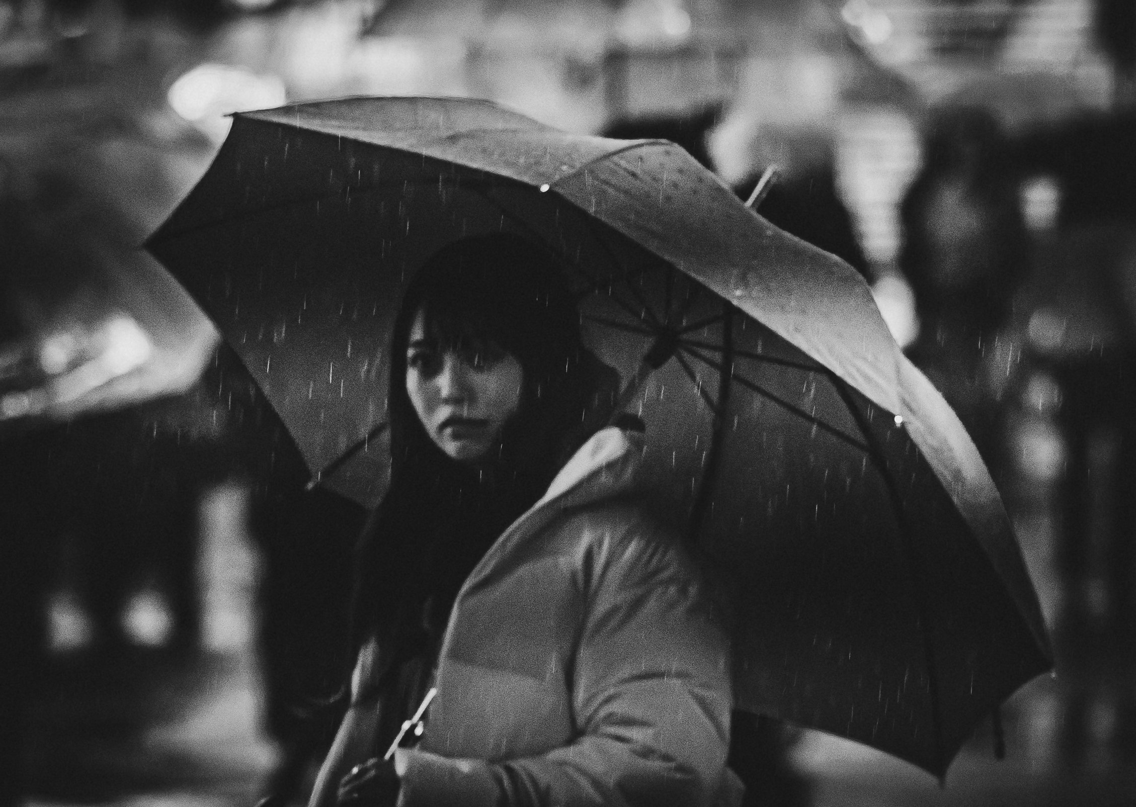 Lady standing in the rain with umbrella.jpg