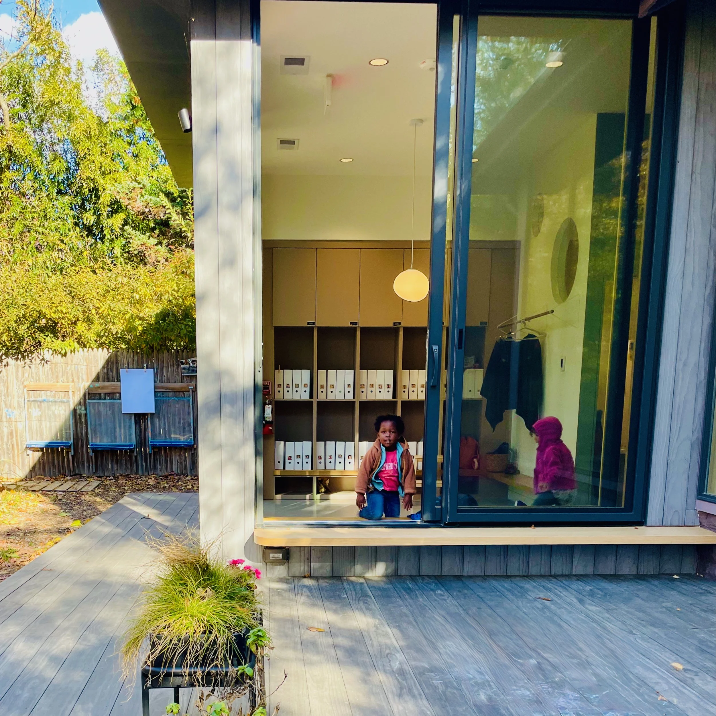 A child explores the view from the renovated outdoor classroom, connecting with nature and the community.