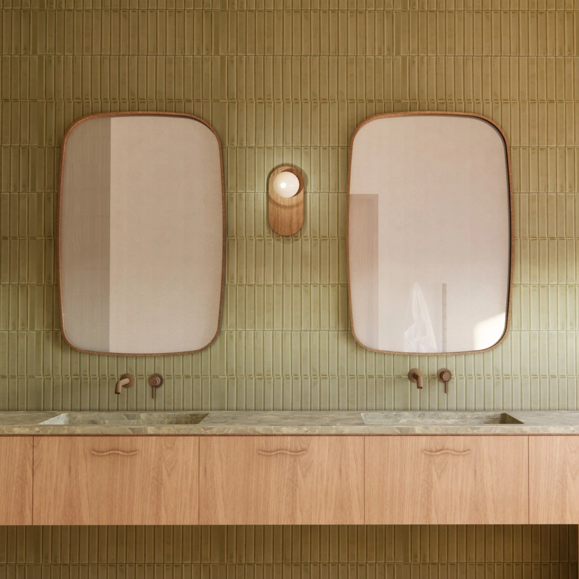 Two wall-mounted mirrors above a double sink bathroom vanity with green tiled wall and wooden cabinet.