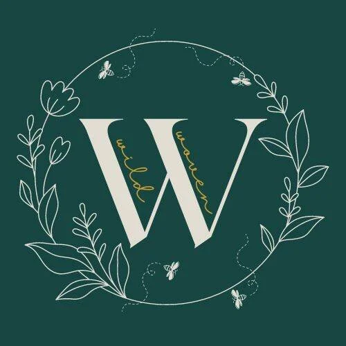 Stylized letter W surrounded by a circular floral wreath with butterflies and leaves, green background