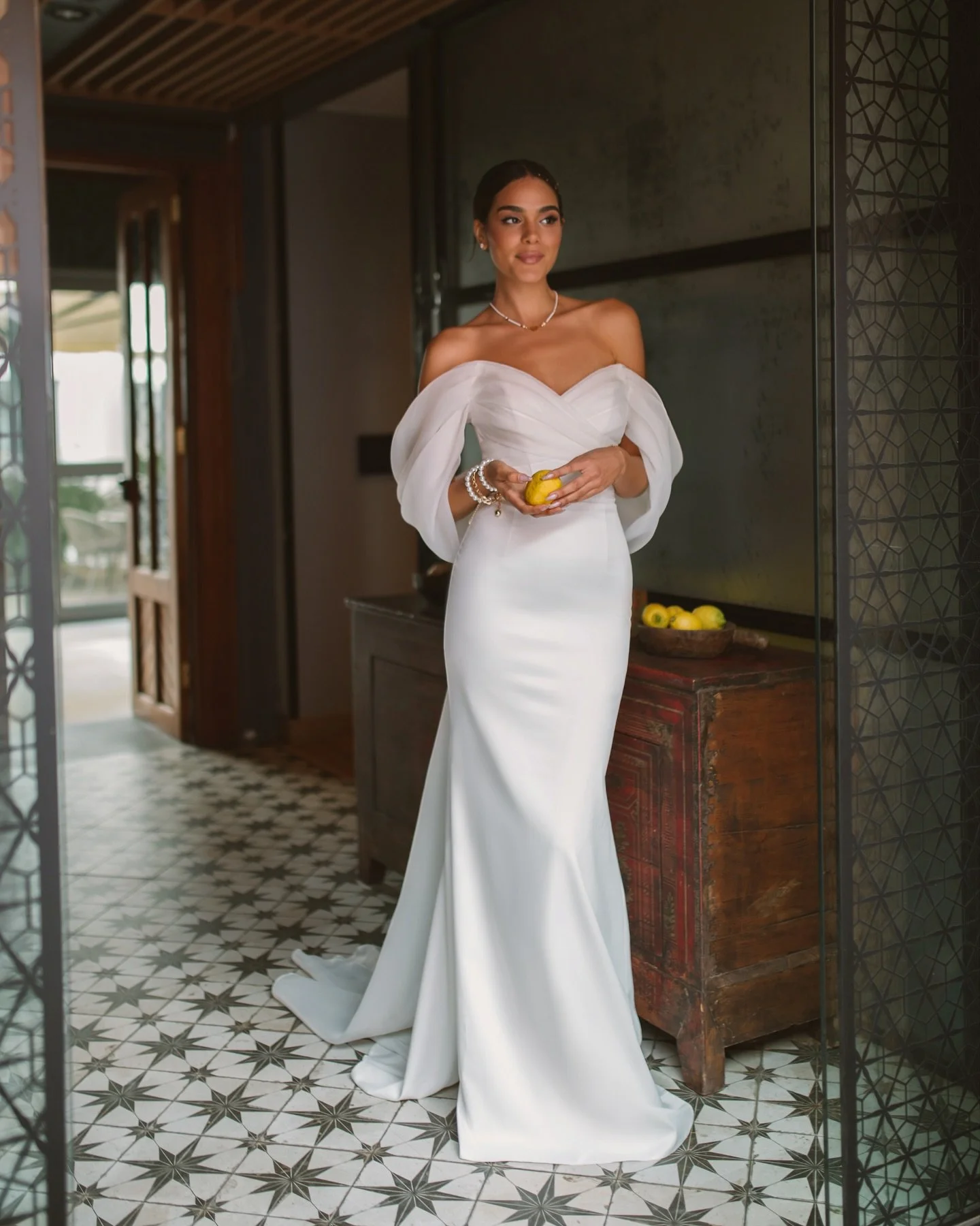 The Vetta Gown: Effortless allure with a touch of modern grace.
One of our newest arrivals &mdash; a gown that combines sleek minimalism with soft, romantic draping. Flowing organza sleeves and a clean silhouette create a look that feels both timeles