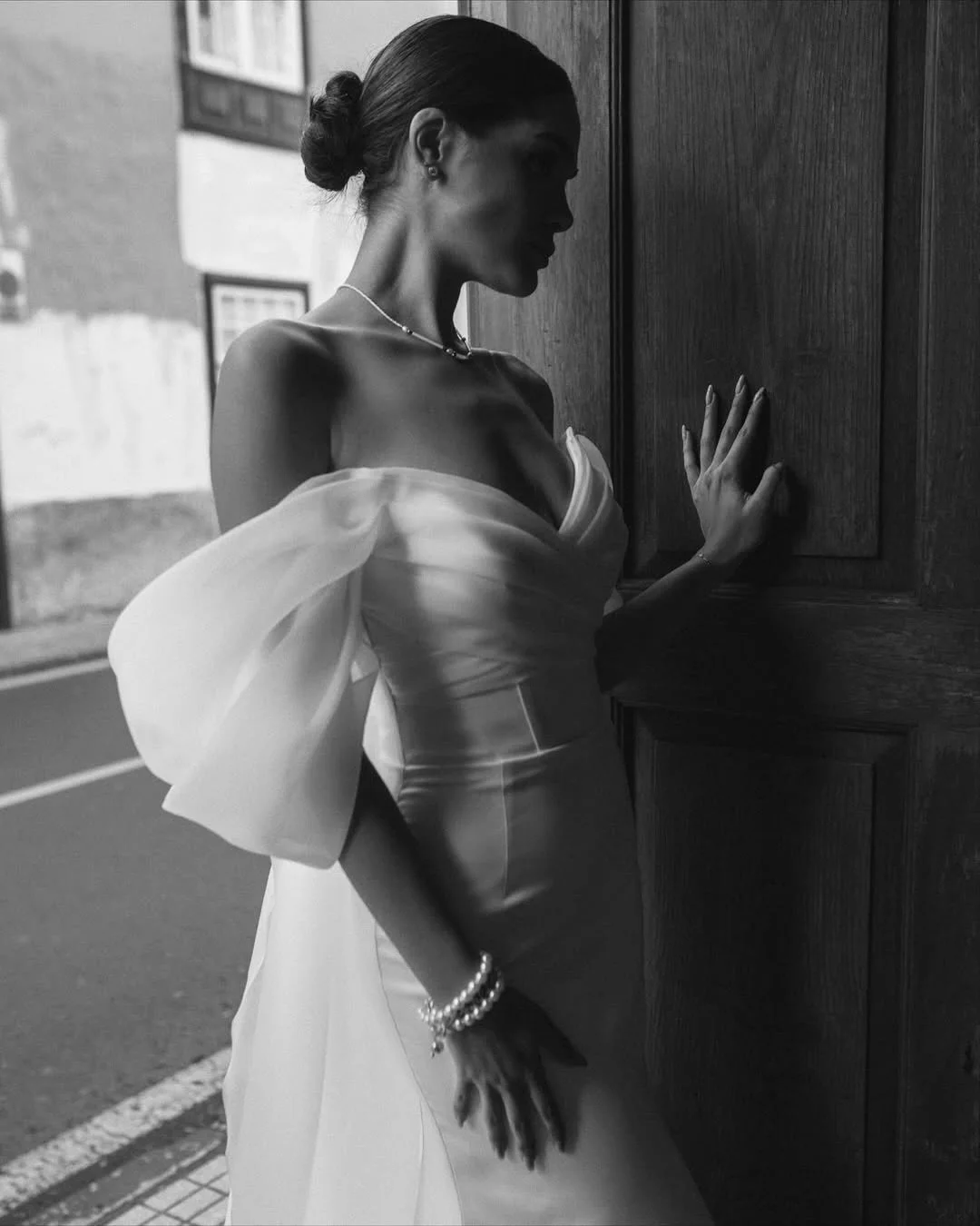 The Vetta Gown: Effortless allure with a touch of modern grace.
One of our newest arrivals &mdash; a gown that combines sleek minimalism with soft, romantic draping. Flowing organza sleeves and a clean silhouette create a look that feels both timeles