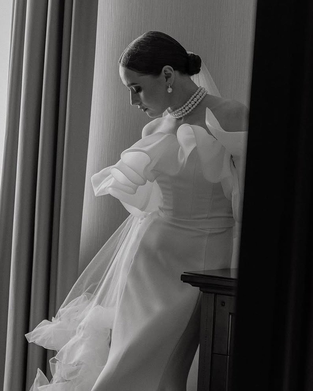 The Vetta Gown: Effortless allure with a touch of modern grace.
One of our newest arrivals &mdash; a gown that combines sleek minimalism with soft, romantic draping. Flowing organza sleeves and a clean silhouette create a look that feels both timeles